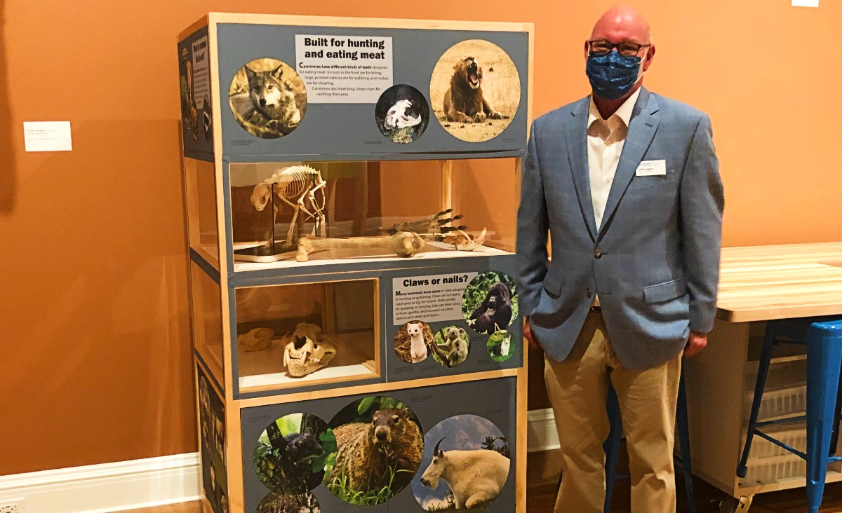 Executive Director Jeff Rodgers beside one of the mobile museum units, smaller displays that can travel to schools and other locations.