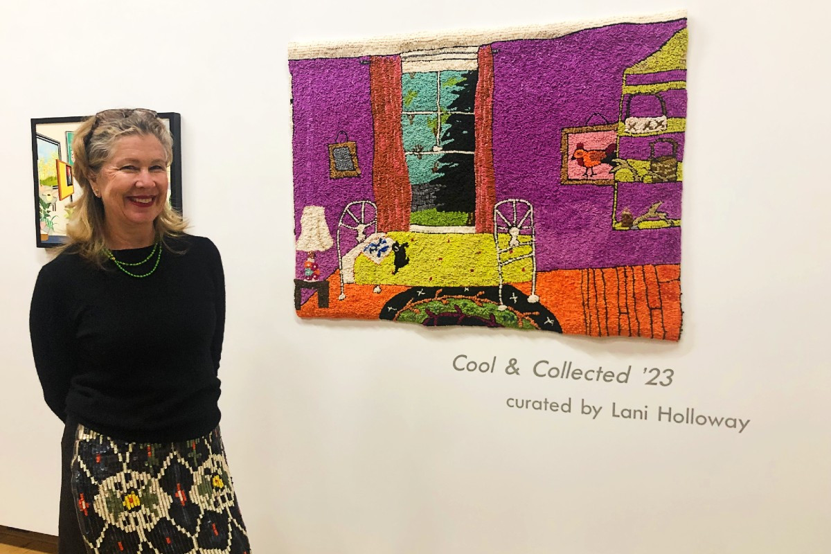 Gallerist Kenise Barnes beside Mary Tooley Parker's "Spare Room," 2022, hooked tapestry, 36x49 inches