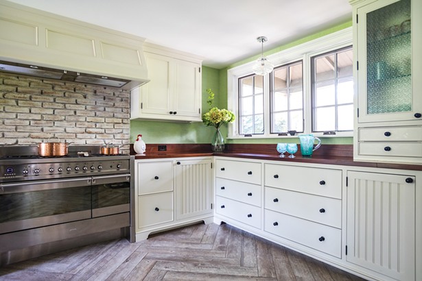 The house’s original woodstove (it’s now in Jackson's carpentry shop) was replaced with a stainless steel six-burner stove. The kitchen is finished in African ribbon-striped sapele wood on the counters and pantry cabinets. Jackson added the south-facing window over the counter. “It really brings the outside inside,” he says. The house’s original woodstove (it’s now in Jackson's carpentry shop) was replaced with a stainless steel six-burner stove. The kitchen is finished in African ribbon-striped sapele wood on the counters and pantry cabinets. Jackson added the south-facing window over the counter. “It really brings the outside inside,” he says.