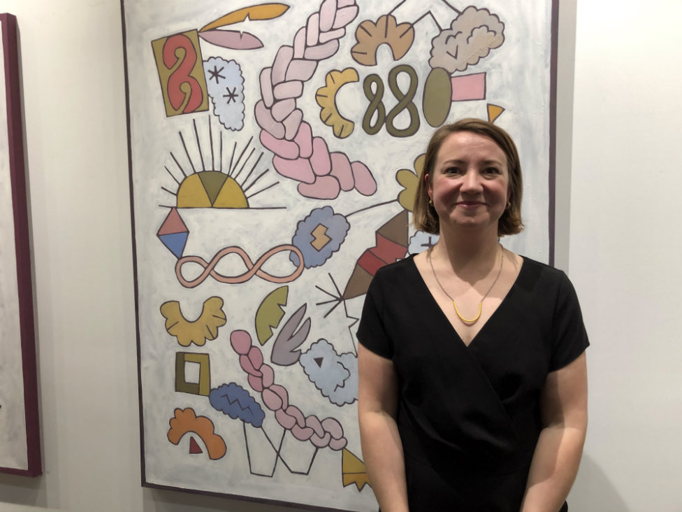 Exhibiting artist Ellie Spangler in front of one of her paintings Exhibiting artist Ellie Spangler in front of one of her paintings