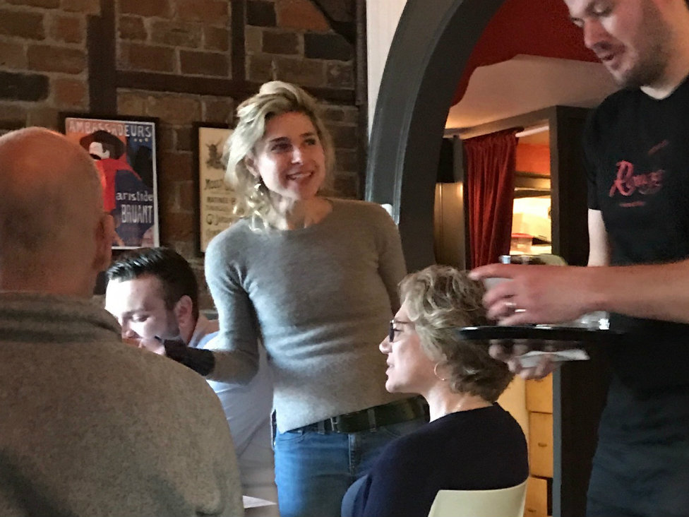 Proprietress Maggie Merelle chats with guests - Mary A. Nelen