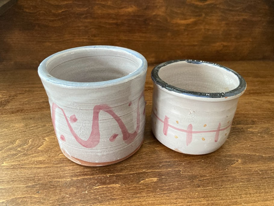 The writer's mementos of her daughters' time at Flying Cloud Institute. In keeping with tradition, each camper received a wheel-thrown, hand-painted, personalized mug made by Jane Burke (who is also an environmentalist) for use during their time at camp. Photo credit: Hannah Van Sickle