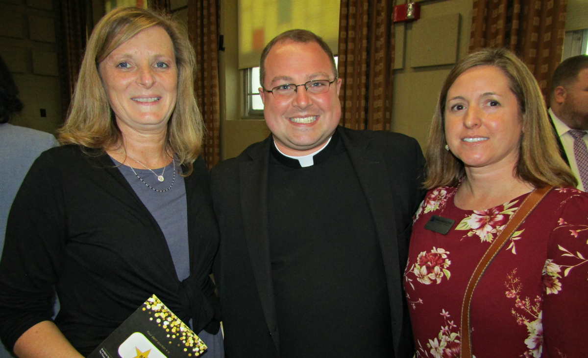 Lisa Mineau and Beth Petropulos of MountainOne flank Father Matt Alcombright. Lisa Mineau and Beth Petropulos of MountainOne flank Father Matt Alcombright.