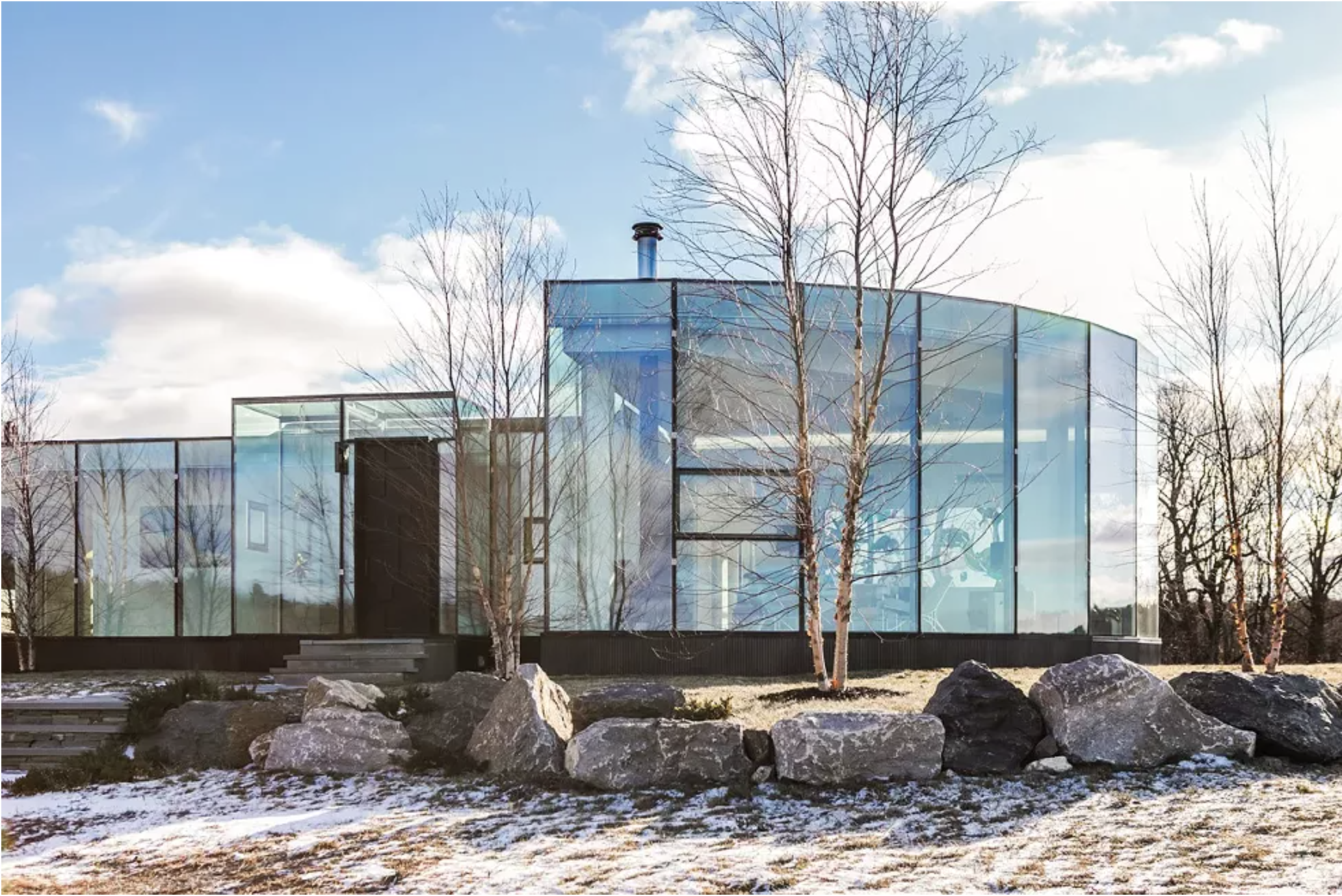 The home sits on a former horse farm in the middle of an abandoned paddock. Working with Tivoli-based engineer Franz Safford, the couple incorporated skyscraper-grade glass as exterior walls. An interior steel mullion frame holds together the home without breaching the glass and maximizing the insulation. - Winona Barton-Ballentine
