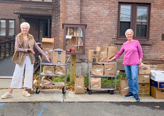 Karen Rostang and Jan Wallace are ready to distribute meals.