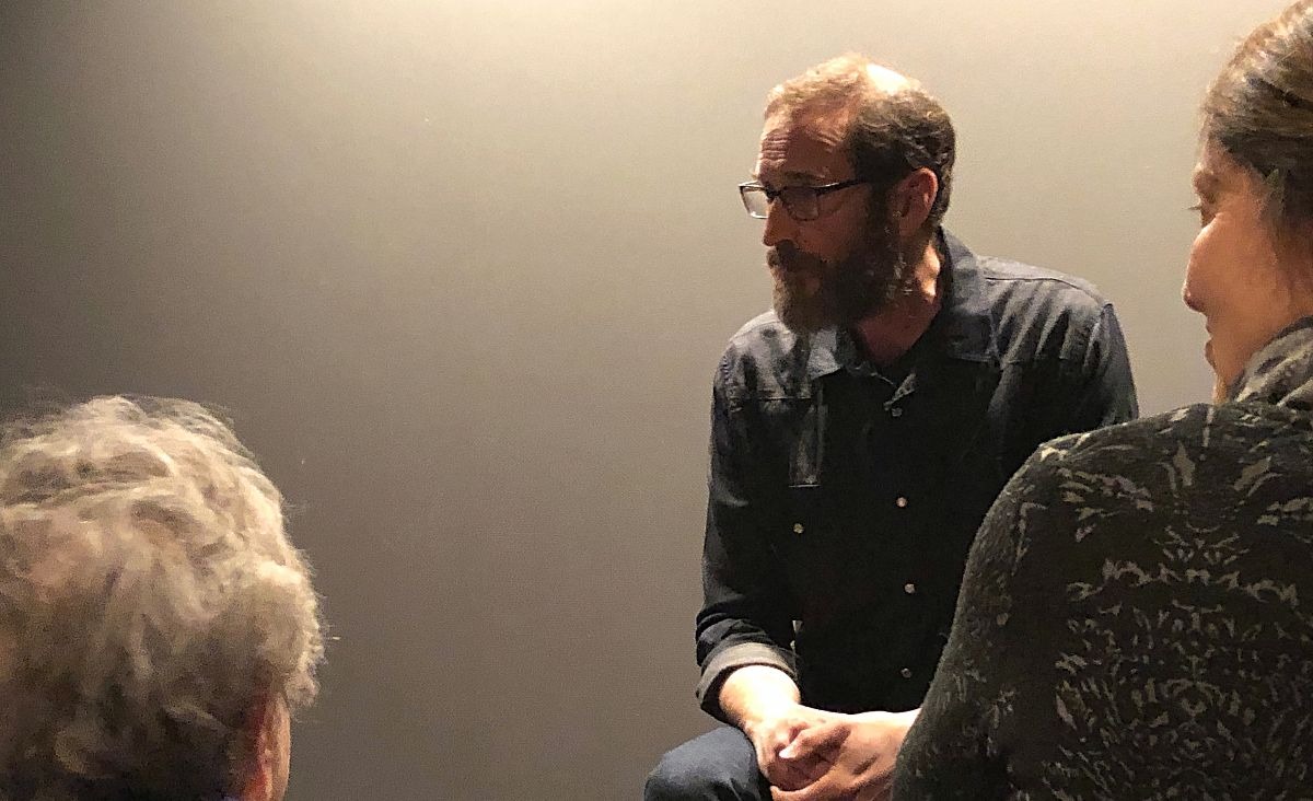 Attendees continue the conversation with filmmaker Tom Bena.&nbsp;