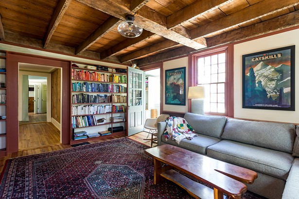 When the Reisfelds purchased the home, the first floor&rsquo;s original dining room had been damaged by a flood. However, it turned out to be a blessing in disguise, uncovering the home&rsquo;s original wood ceiling beams. &ldquo;We knew we couldn&rsquo;t cover them back up,&rdquo; says Reisfeld. &ldquo;They are all hand- cut and you can see the original Roman numerals on some.&rdquo; The family now uses the space as a den. A collection of vintage Milton Glaser prints hangs along the wall.