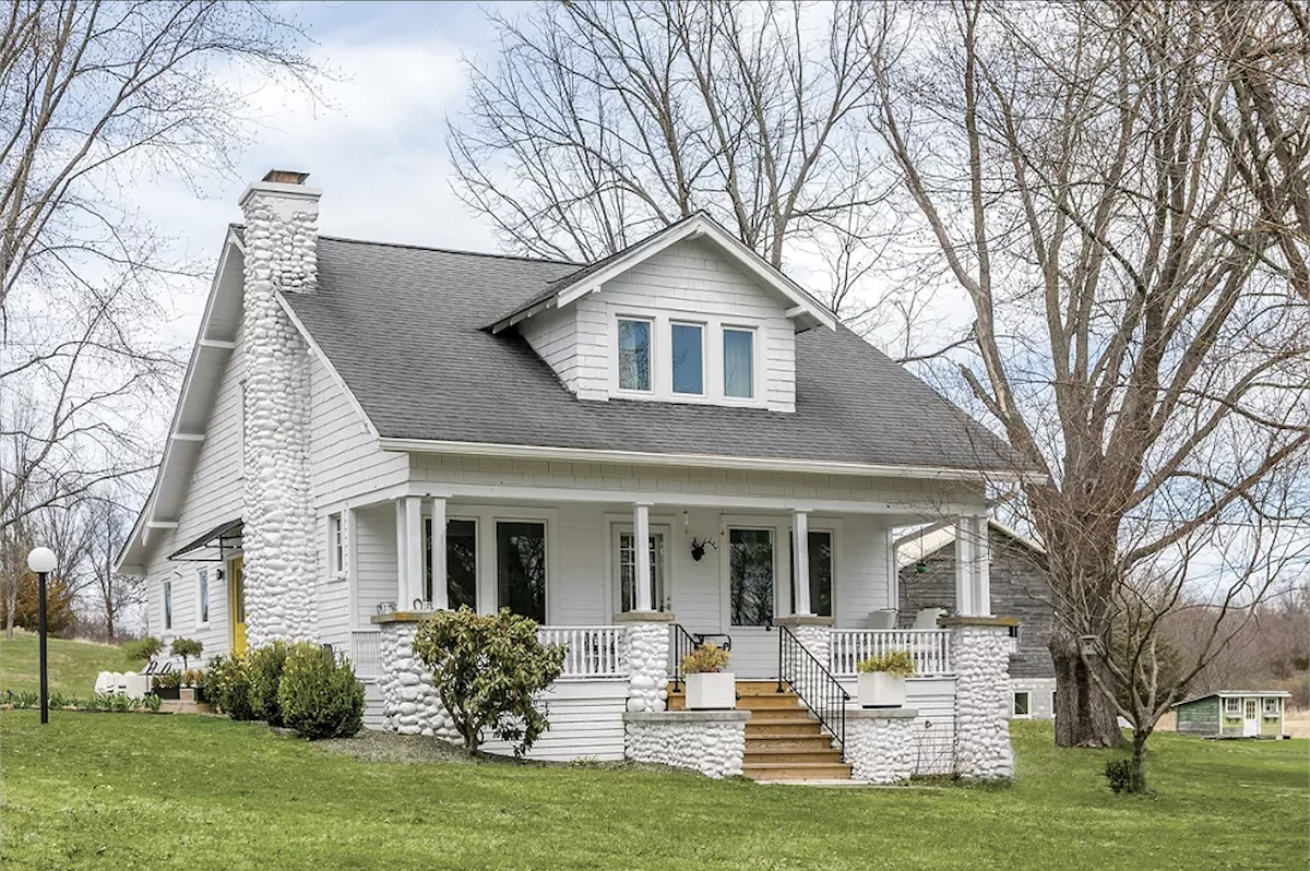 Sitting on 42 acres, the Arts and Crafts home needed a complete overhaul. However, the couple were intent on preserving its history and continuing the story of the home rather than erasing it. After clearing away surrounding overgrowth, the couple livened up the exterior with white - Winona Barton-Ballentine Sitting on 42 acres, the Arts and Crafts home needed a complete overhaul. However, the couple were intent on preserving its history and continuing the story of the home rather than erasing it. After clearing away surrounding overgrowth, the couple livened up the exterior with white - Winona Barton-Ballentine