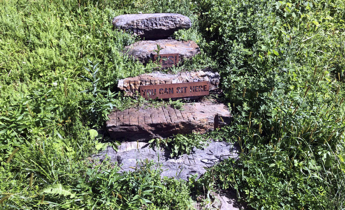 Look closely. The BNRC welcomes hikers with a sign: Yes! You can sit here.