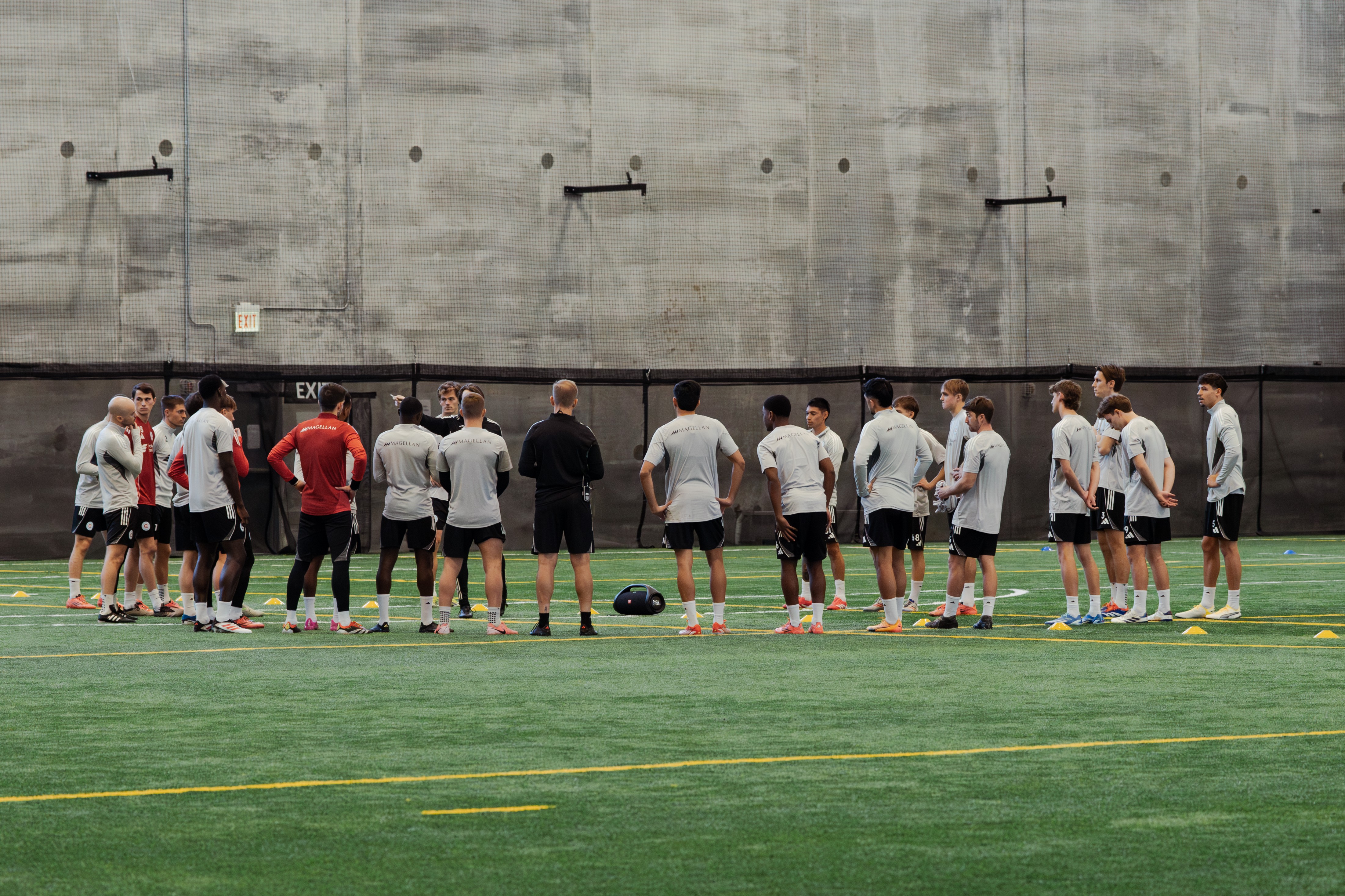 Group of players in green jerseys at the indoor Intentional Sports Complex 