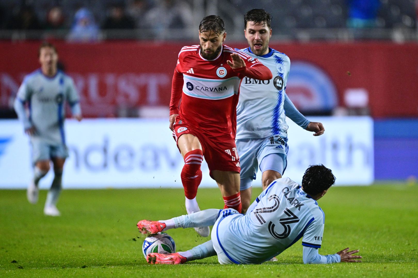Philip Zinckernagel and CF Montreal's Clark battle for the ball at Soldier Field on March 29, 2025
