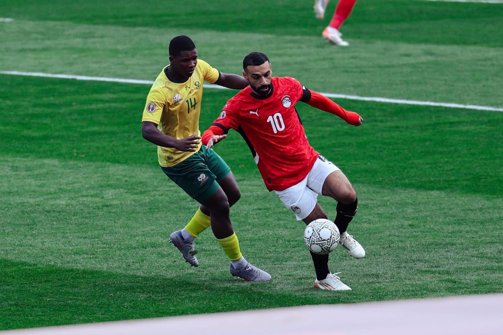 South Africa and Chicago Fire defender Mbekezeli Mbokazi defends against Liverpool and Egypt's Mohamed Mo Salah at the African Cup of Nations in Morocco in 2025.