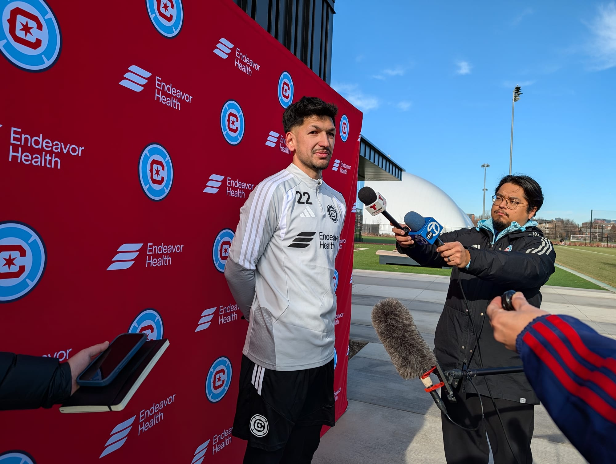 Mauricio Pineda outside on 1/13/2026 in front of a Fire backdrop speaking to reporters
