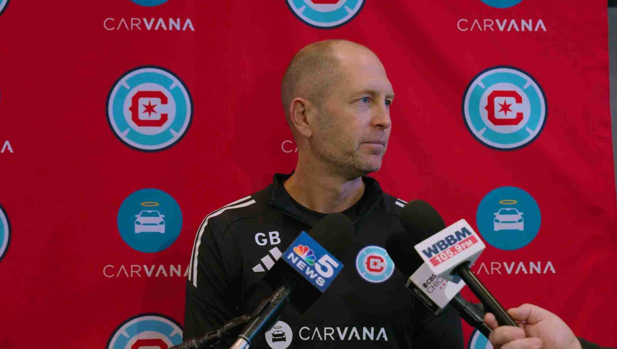 Close in shot of Gregg Berhalter with microphones in front of a Chicago Fire 