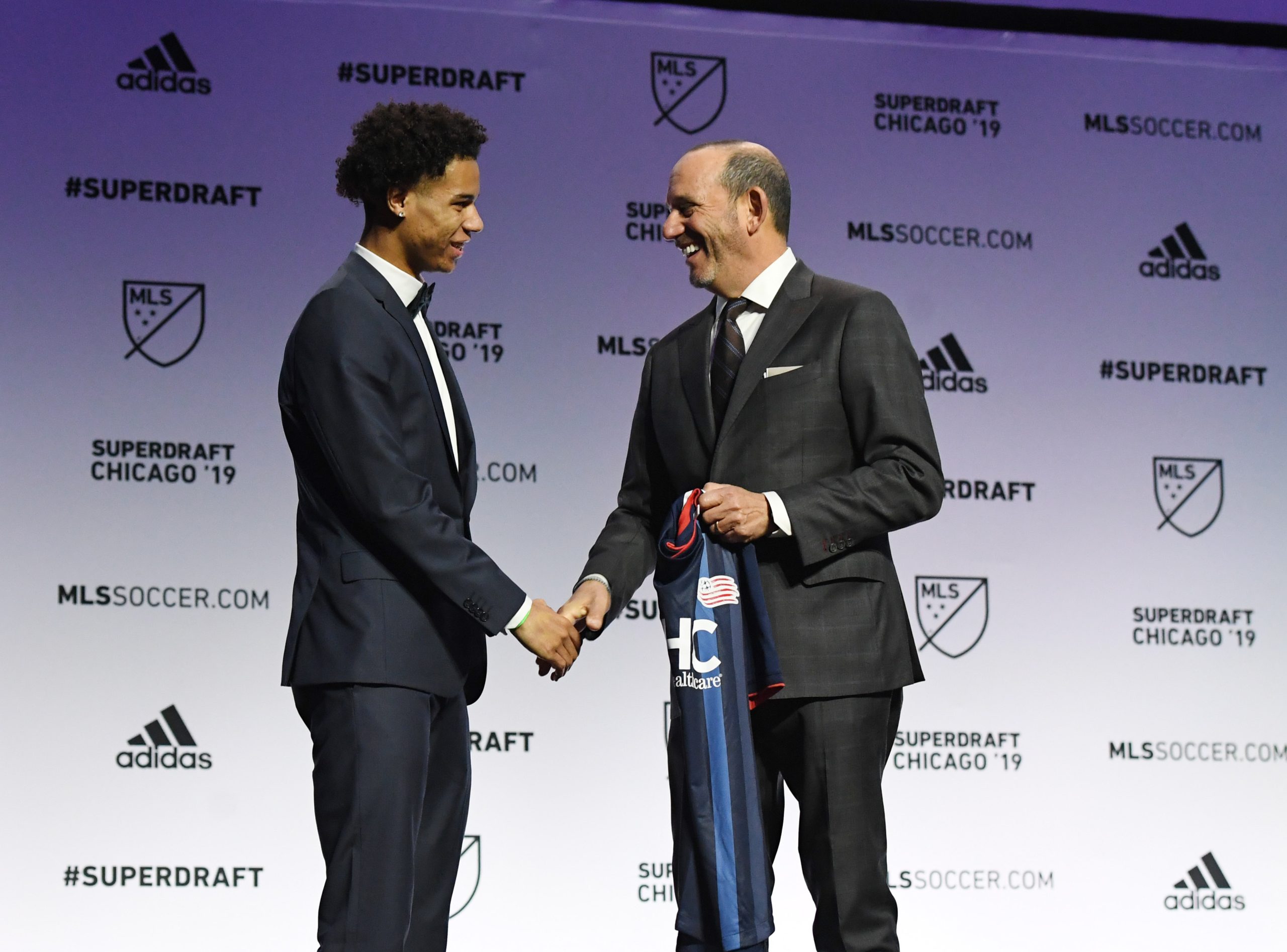 Jan 11, 2019; Chicago, IL, USA; Tajon Buchanan greets MLS commissioner Don Garber after being selected as the number nine overall pick to the New England Revolution in the first round of the 2019 MLS Super Draft at McCormick Place. Mandatory Credit: Mike DiNovo-USA TODAY Sports