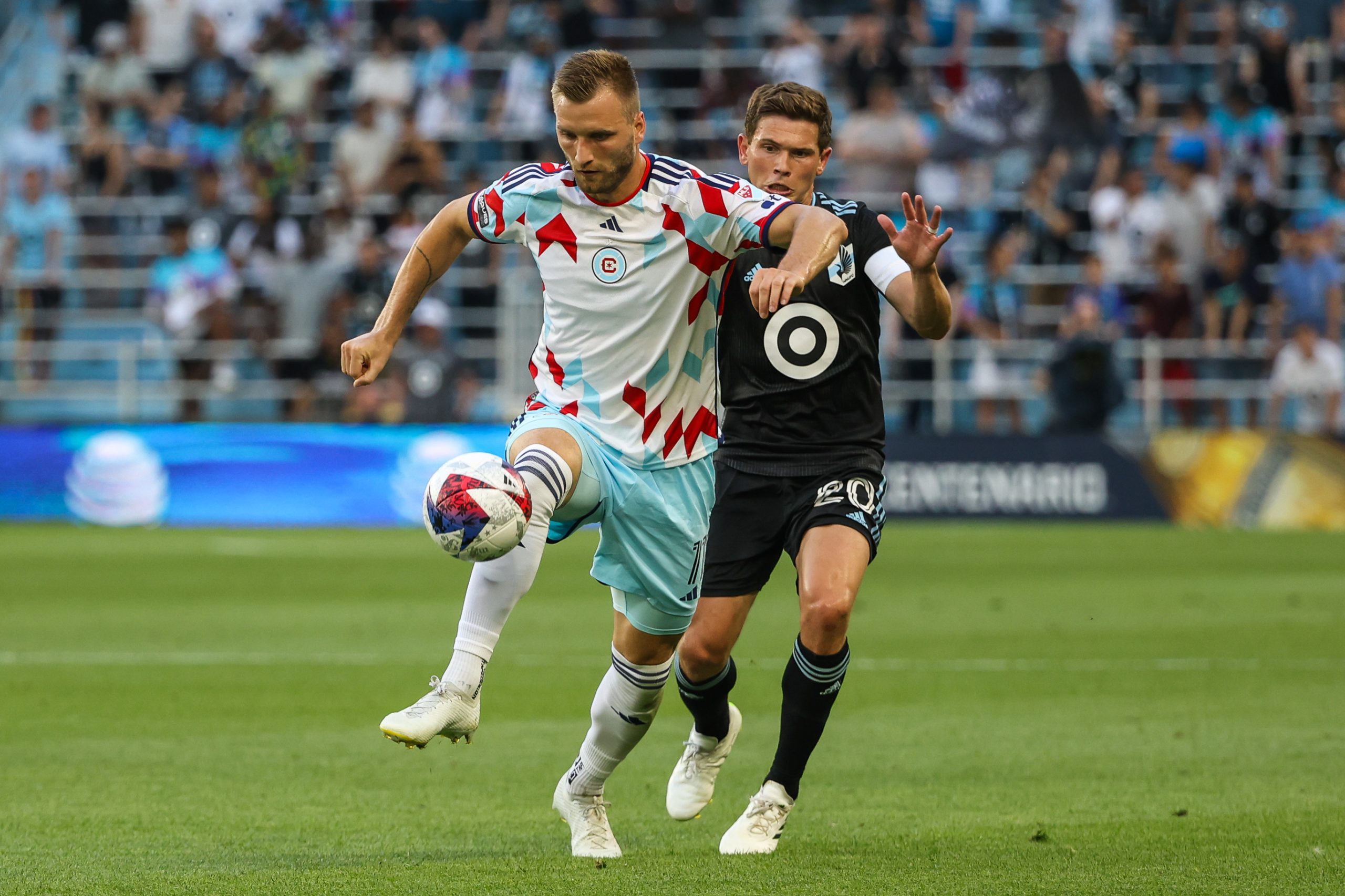 Jul 27, 2023; Saint Paul, MN, USA; Chicago Fire forward Kacper Przybyko (11) controls the ball while Minnesota United midfielder Will Trapp (20) defends at Allianz Field. 