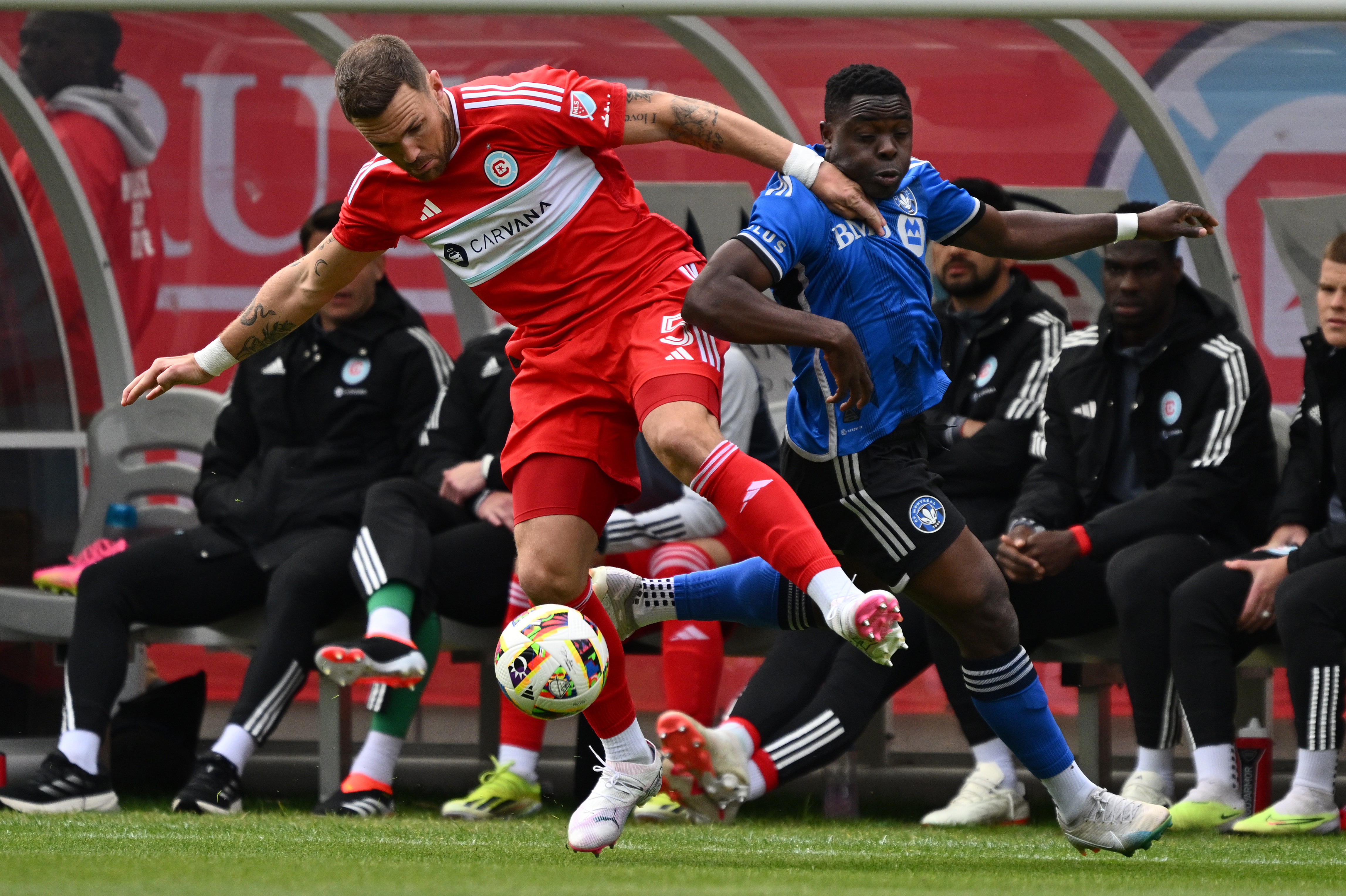 Mar 16, 2024; Chicago, Illinois, USA; Chicago Fire FC defender Rafael Czichos (5) and CF Montreal forward Sunusi Ibrahim (14) battle for a ball during the first half at Soldier Field.