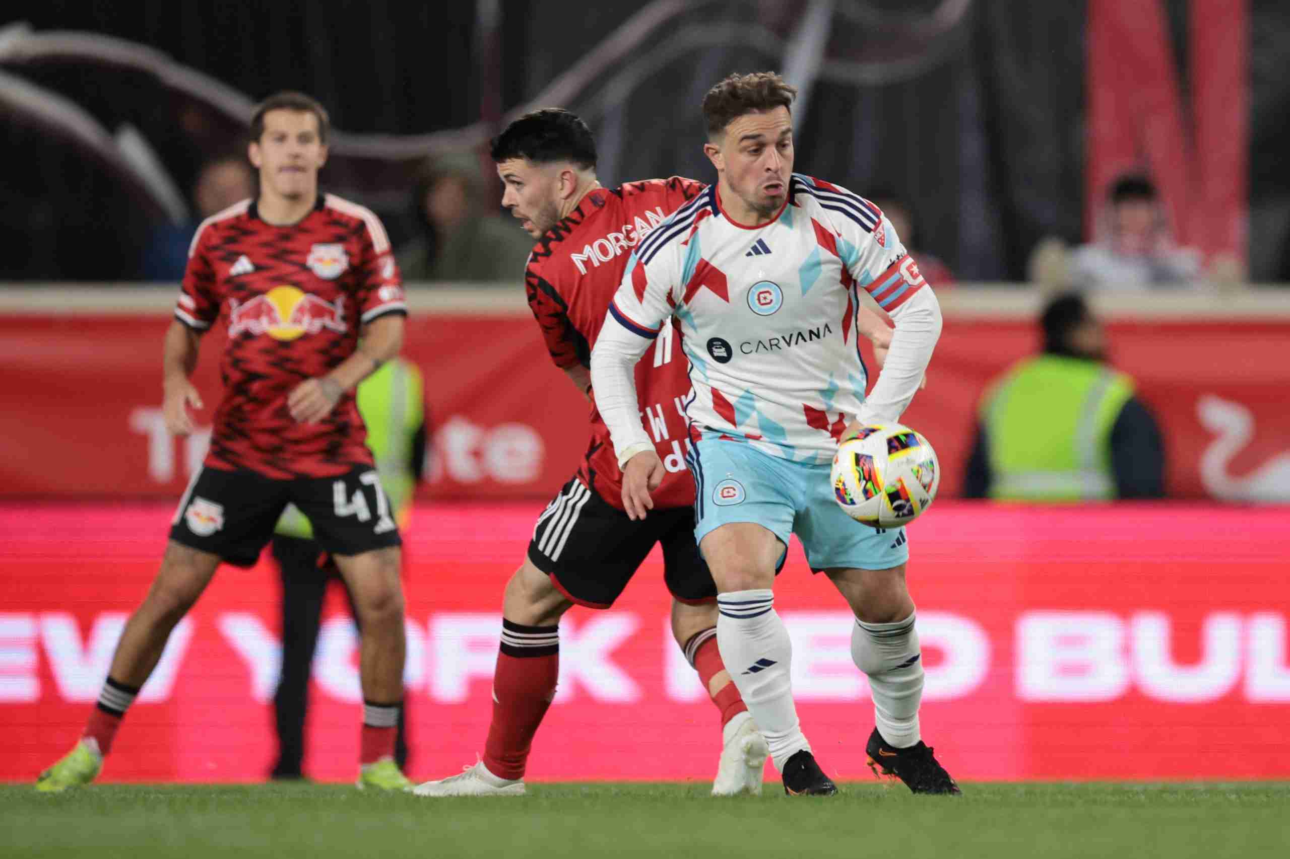 Apr 13, 2024; Harrison, New Jersey, USA; Chicago Fire FC midfielder Xherdan Shaqiri (10) battles for the ball against New York Red Bulls midfielder Lewis Morgan (9) during the first half at Red Bull Arena.