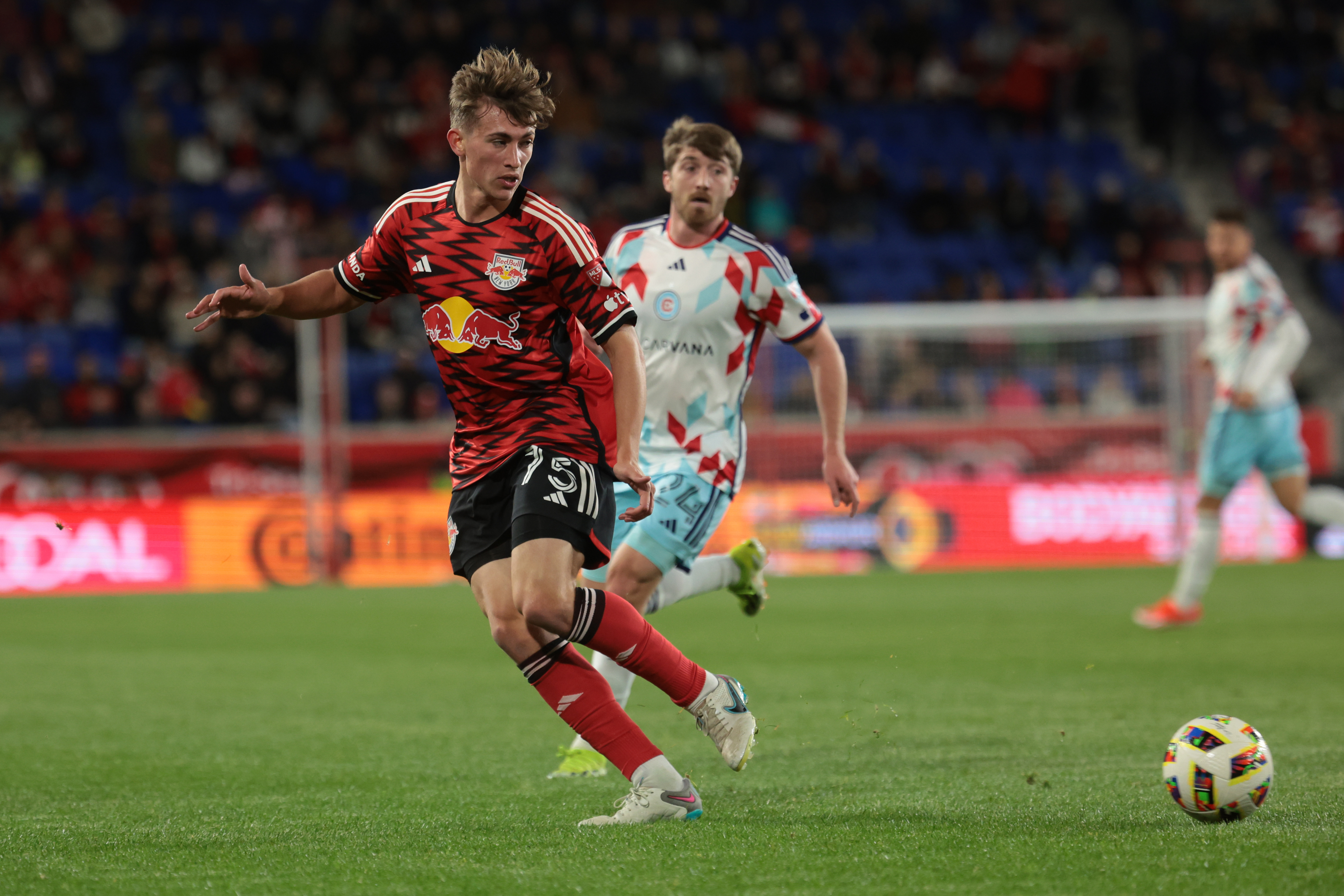 Apr 13, 2024; Harrison, New Jersey, USA; New York Red Bulls midfielder Daniel Edelman (75) and Chicago Fire FC midfielder Jonathan Dean (24) pursue the ball during the second half at Red Bull Arena. 