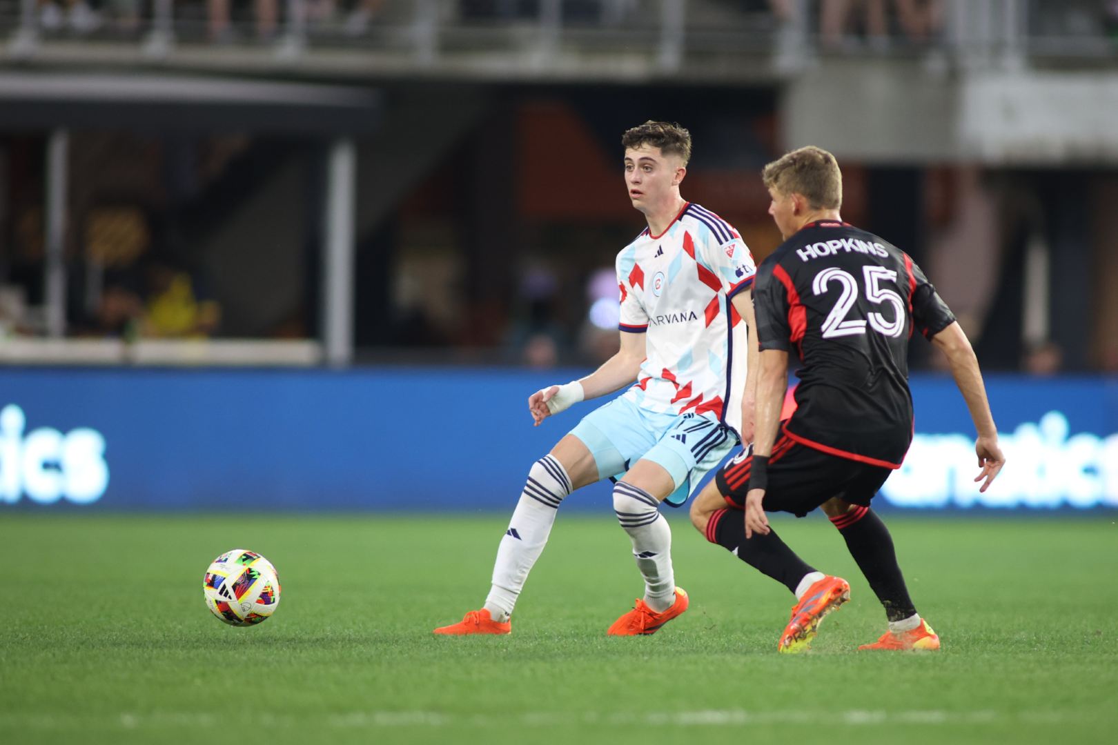 May 25, 2024; Washington, District of Columbia, USA; Chicago Fire midfielder Brian Gutierrez (17) plays the ball defended by D.C. United midfielder Jackson Hopkins (25) in the first half at Audi Field. 