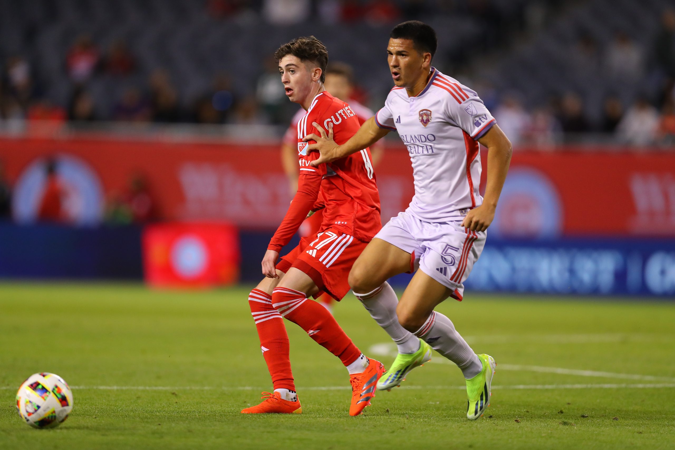 May 29, 2024; Chicago, Illinois, USA; Chicago Fire FC midfielder Brian Gutierrez (17) and Orlando City midfielder Cesar Araujo (5) battle for the ball during their MLS soccer match at Soldier Field.