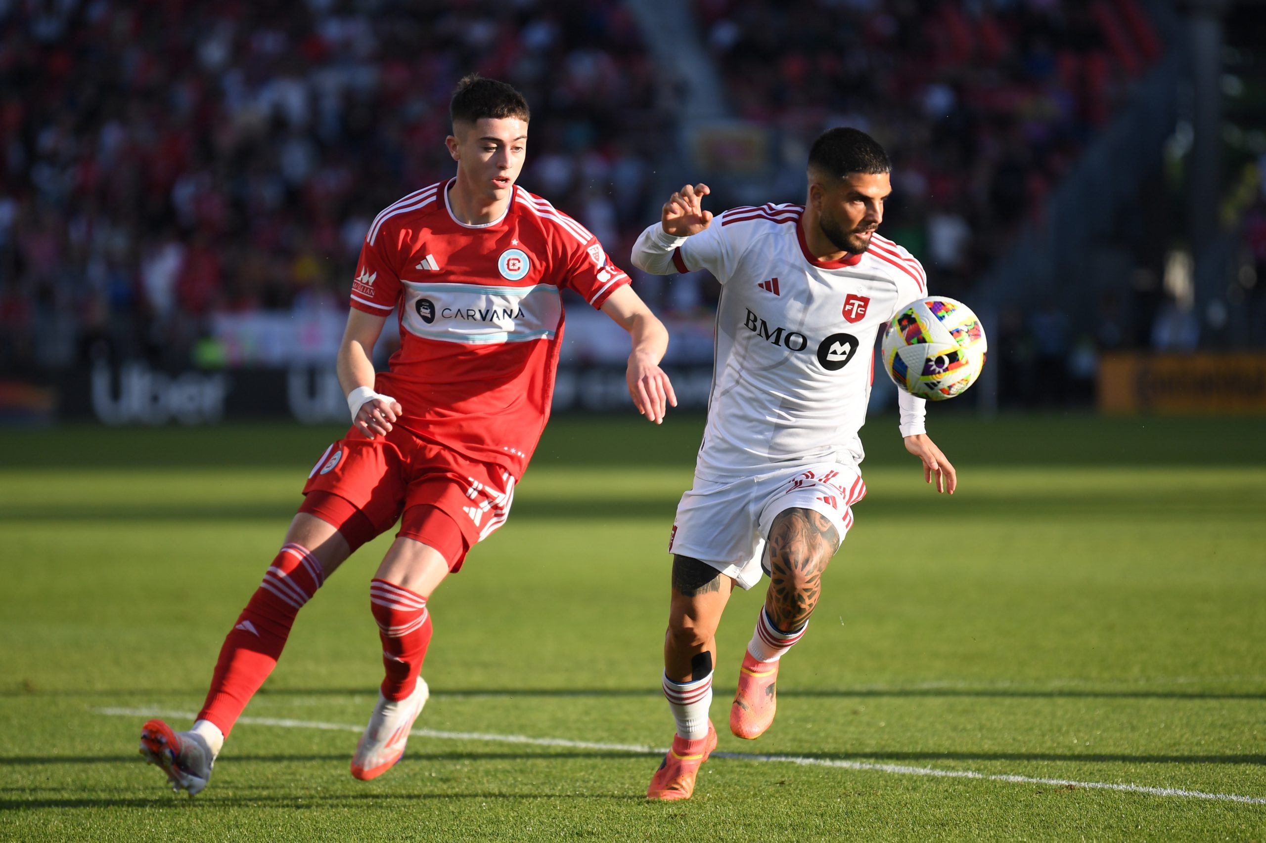 Jun 15, 2024; Toronto, Ontario, CAN; Toronto FC forward Lorenzo Insigne (24) and Chicago Fire FC midfielder Brian Gutierrez (17) battle for the ball in the first half at BMO Field. 