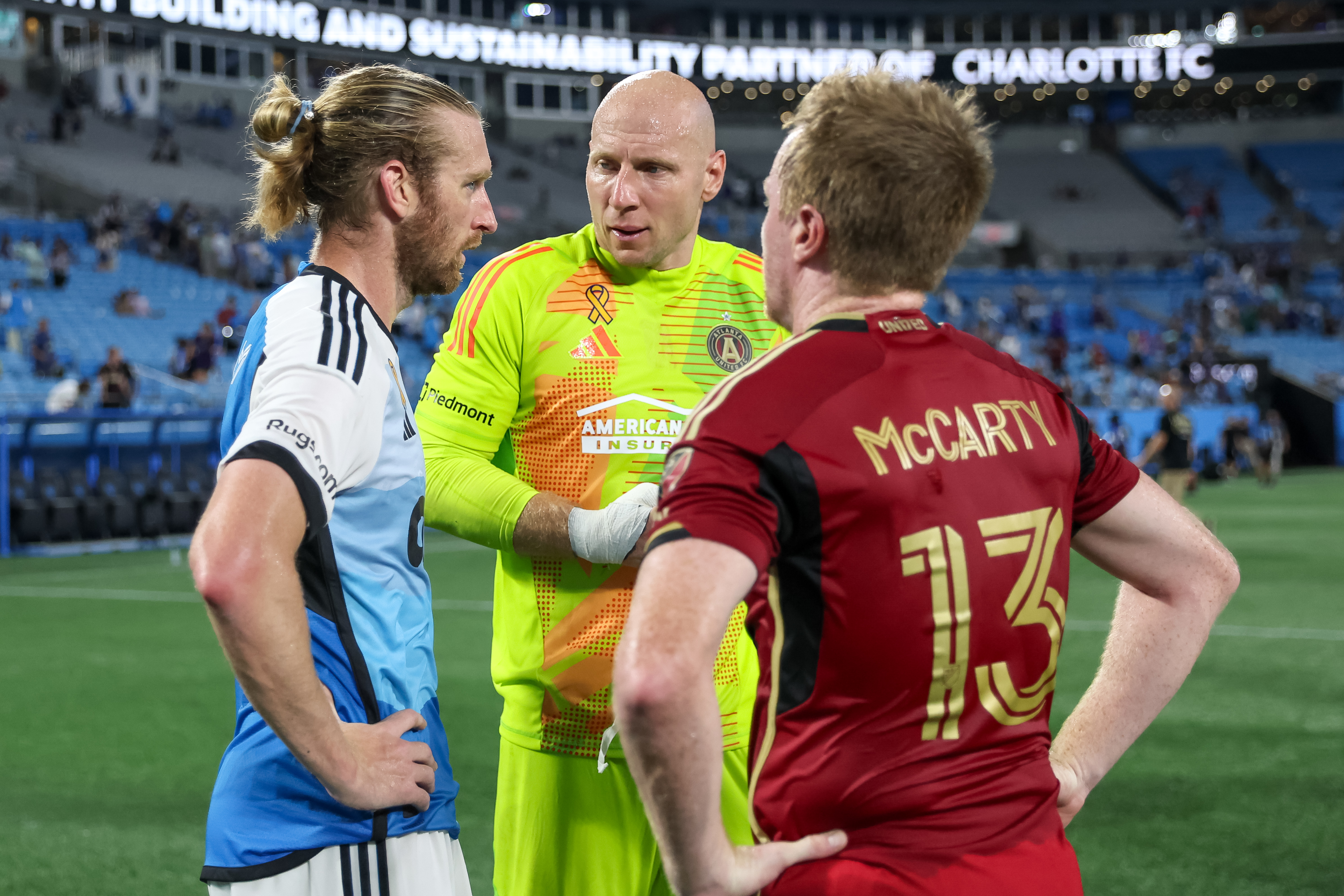 Aug 31, 2024; Charlotte, North Carolina, USA;  Charlotte FC defender Tim Ream (3) talks with Atlanta United midfielder Dax McCarty (13) and Atlanta United goalkeeper Brad Guzan (1) after the second half at Bank of America Stadium 