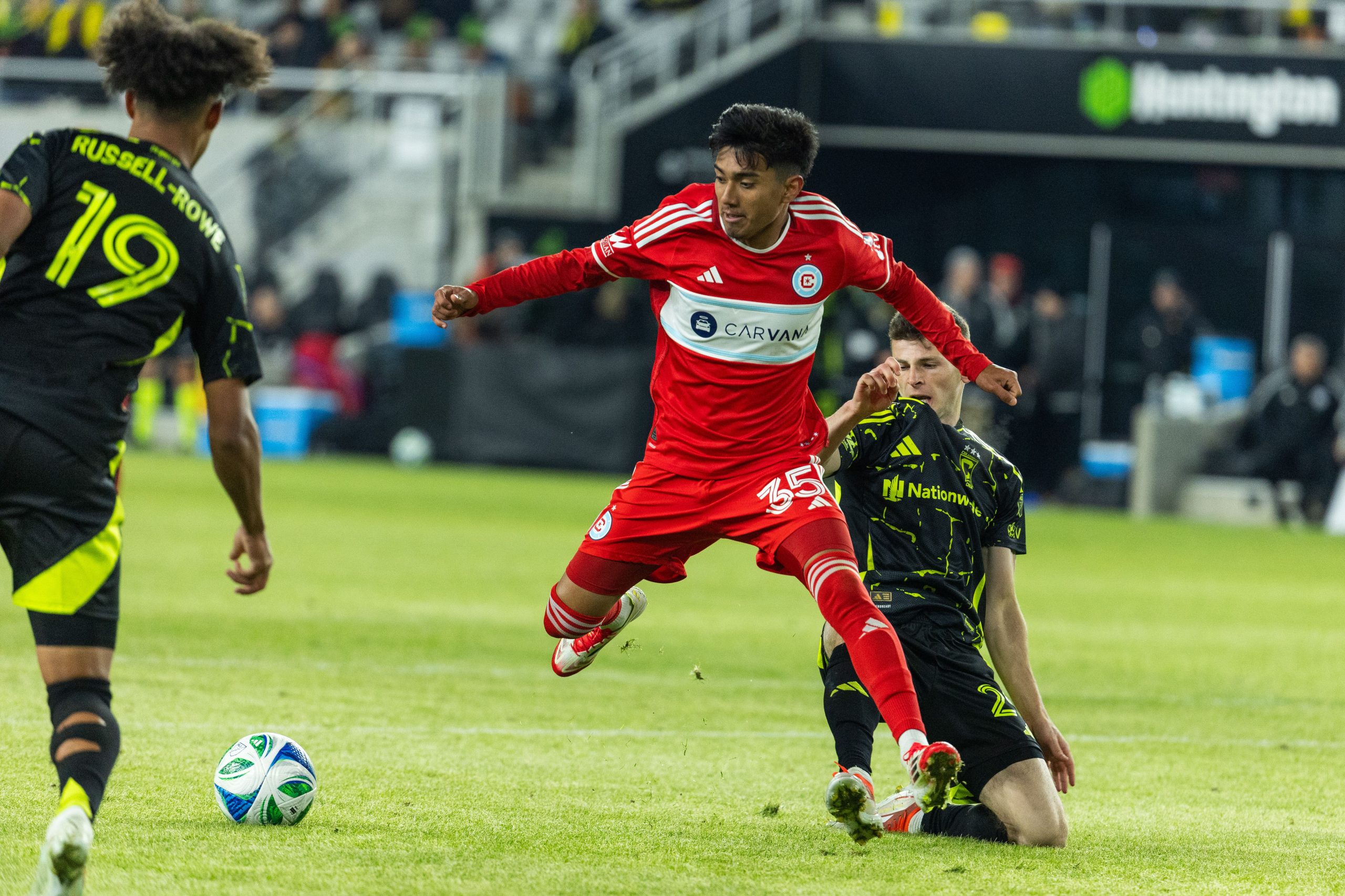 Feb 22, 2025; Columbus, Ohio, USA; Chicago Fire FC midfielder Sergio Oregel (35) dribbles the ball while Columbus Crew midfielder Sean Zawadzki (25) defends in the second half at Lower.com Field. Mandatory Credit: Trevor Ruszkowski-Imagn Images