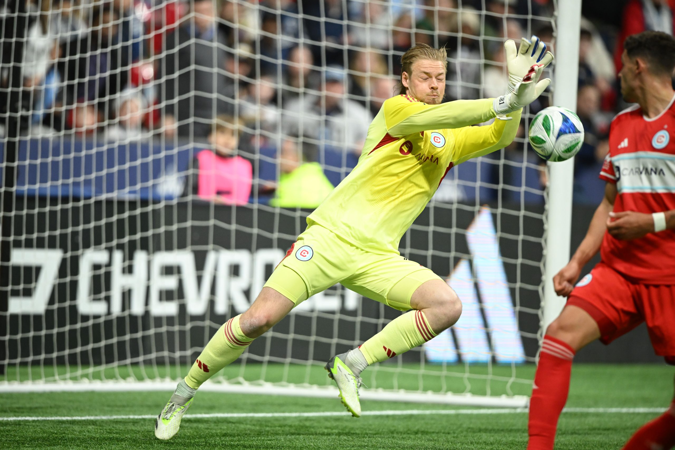Mar 22, 2025; Vancouver, British Columbia, CAN; Chicago Fire FC goalkeeper Chris Brady (1) blocks a shot on goal during the first half against the Vancouver Whitecaps FC at BC Place. Mandatory Credit: 