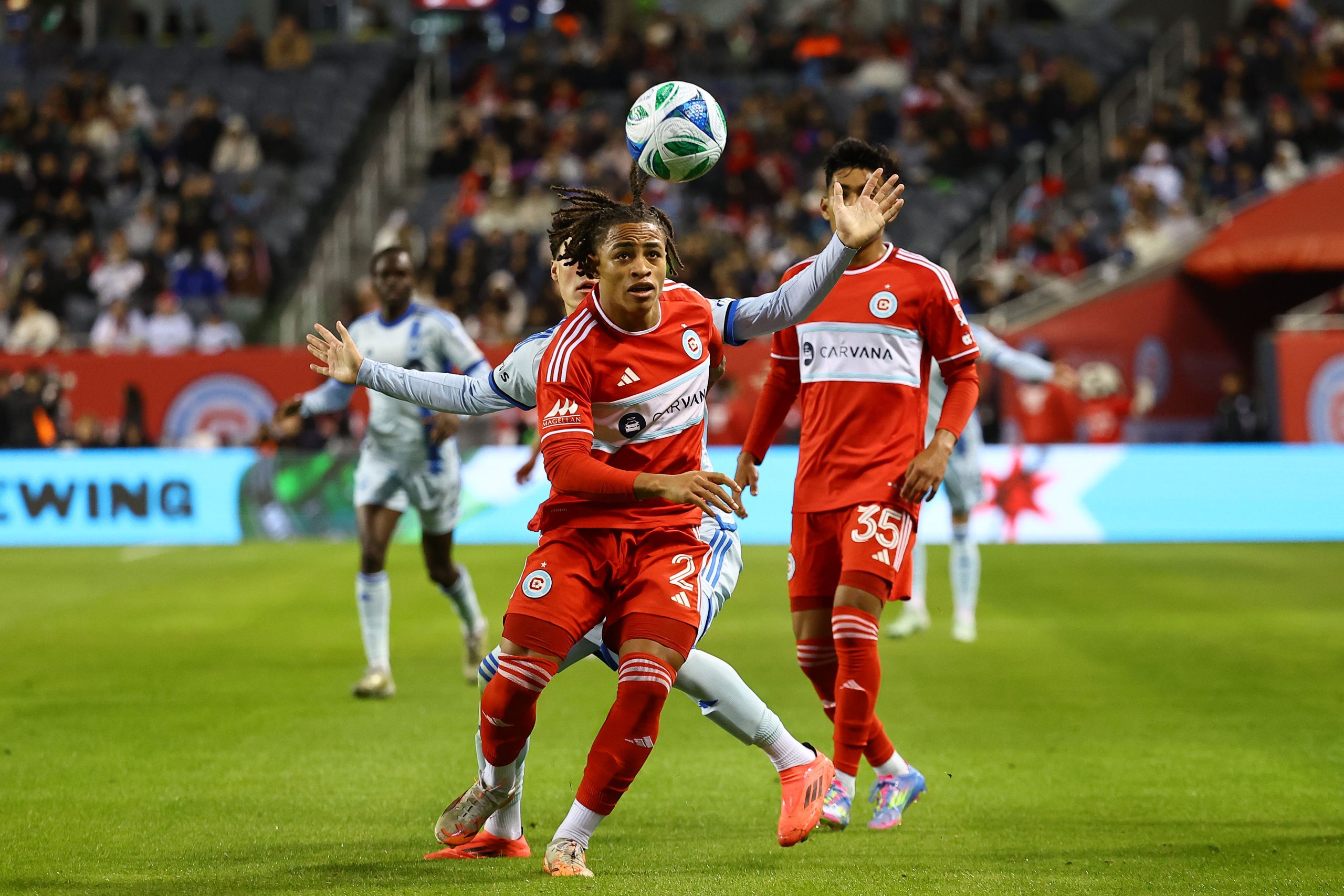 Mar 29, 2025; Chicago, Illinois, USA; CF Montreal midfielder Caden Clark (23) and Chicago Fire FC defender Leonardo Barroso (2) attempt to get a ball during the first half at Soldier Field. Mandatory Credit: Mike Dinovo-Imagn Images