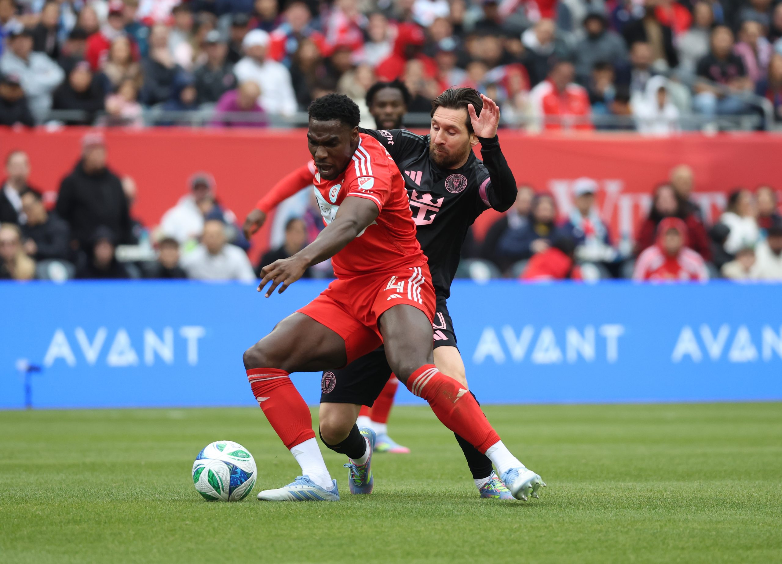 Apr 13, 2025; Chicago, Illinois, USA; Chicago Fire FC defender Carlos Tern (4) and Inter Miami CF forward Lionel Messi (10) battle for control of the ball during the first half at Soldier Field. Mandatory Credit: Talia Sprague-Imagn Images