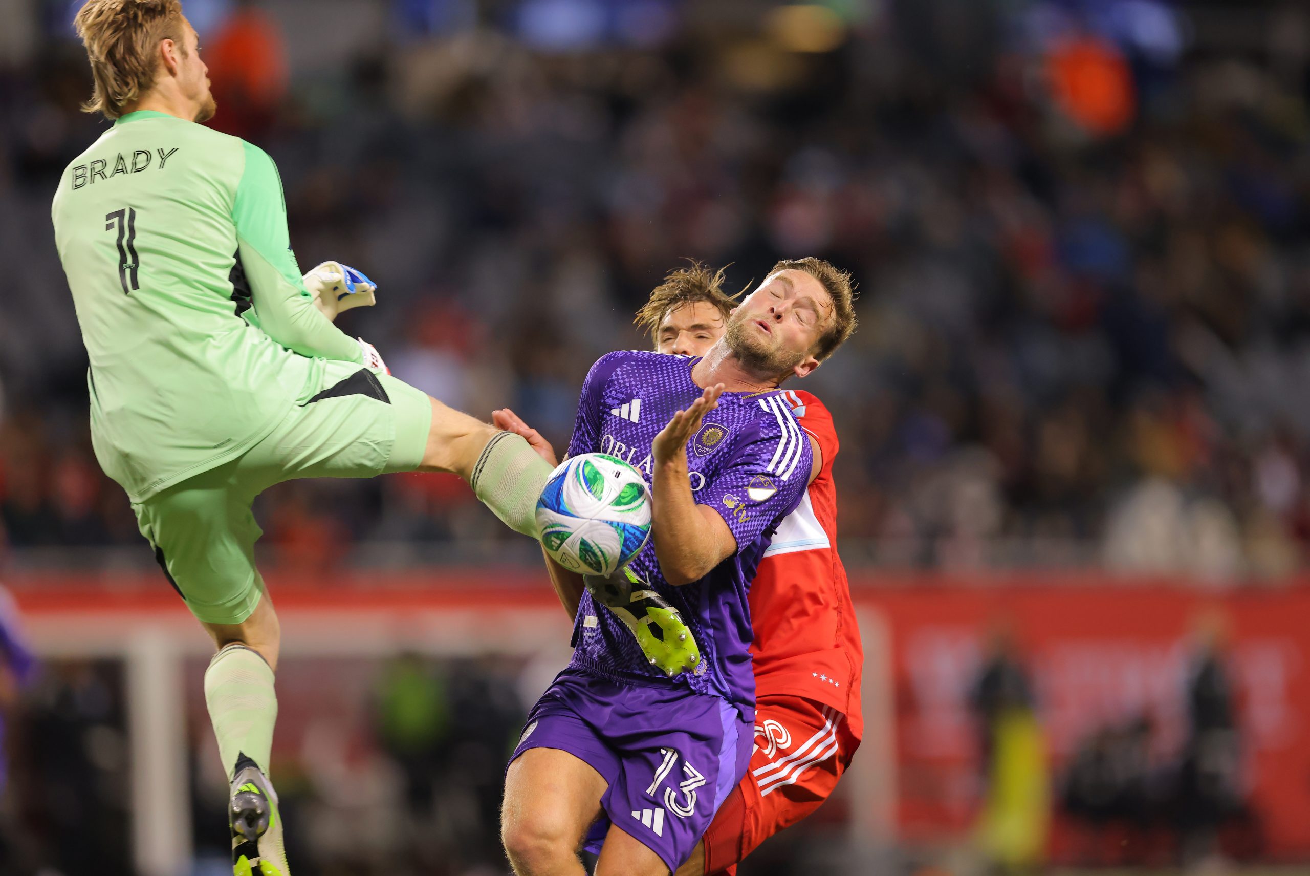 May 3, 2025; Chicago, Illinois, USA; Chicago Fire FC goalkeeper Chris Brady (1) kicks Orlando City forward Duncan McGuire (13) during the first half at Soldier Field.