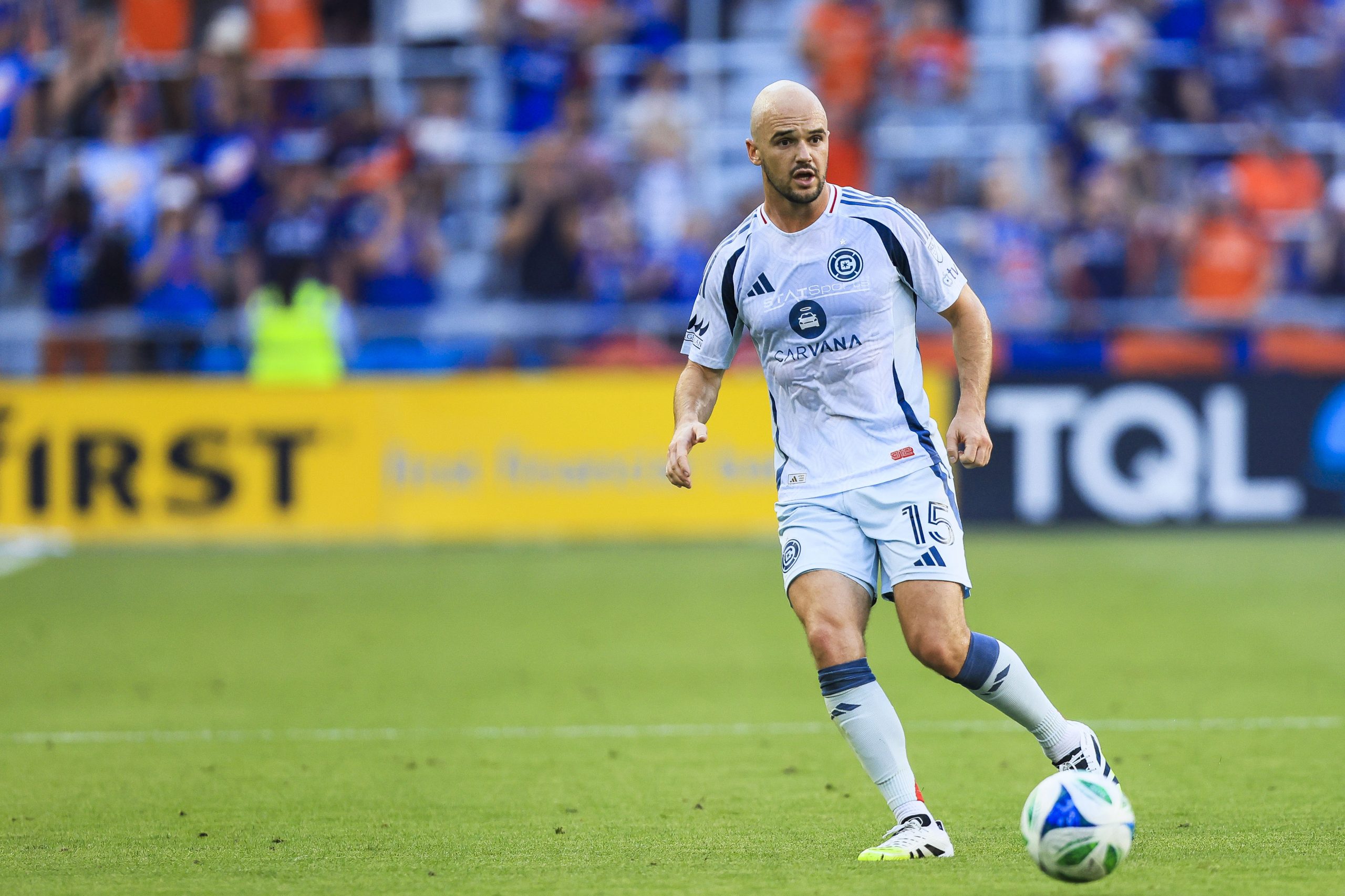 Jul 5, 2025; Cincinnati, Ohio, USA; Chicago Fire FC defender Andrew Gutman (15) dribbles against FC Cincinnati in the first half at TQL Stadium. Mandatory Credit: Katie Stratman-Imagn Images