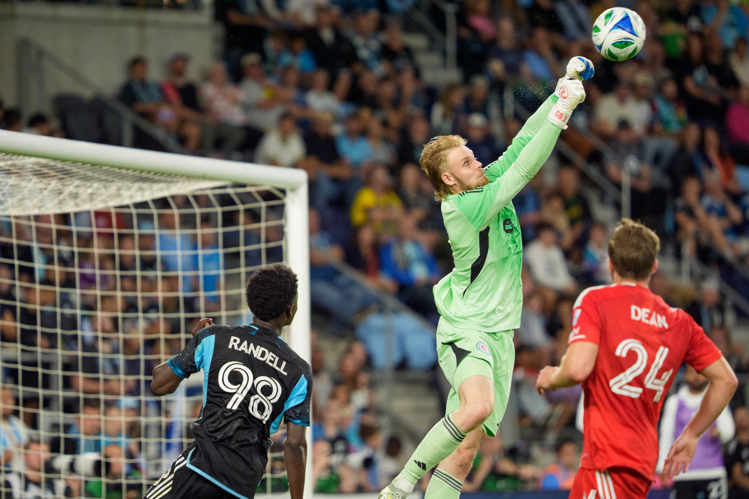 Sep 20, 2025; Saint Paul, Minnesota, USA; Chicago Fire goaltender Chris Brady (1) punches the ball away from Minnesota United forward Darius Randell (98) in the first half at Allianz Field. Mandatory Credit: Matt Blewett-Imagn Images