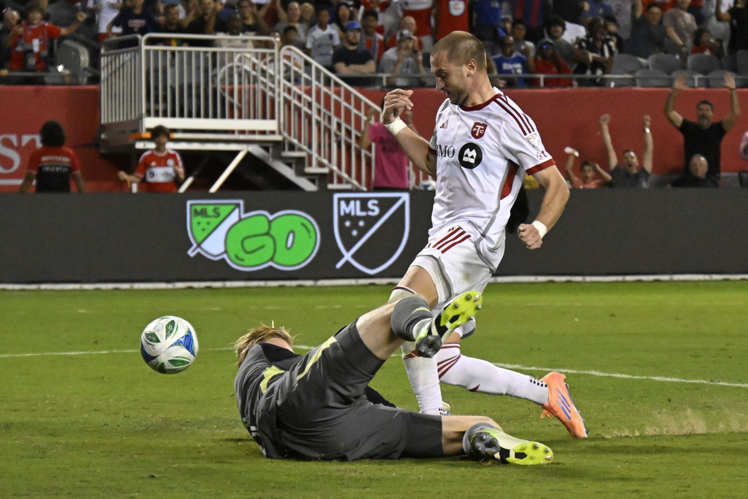 Oct 4, 2025; Chicago, Illinois, USA; Toronto FC midfielder Djordje Mihailović (10) scores past Chicago Fire goalkeeper Chris Brady (1) during the second half at Soldier Field. Mandatory Credit: Matt Marton-Imagn Images