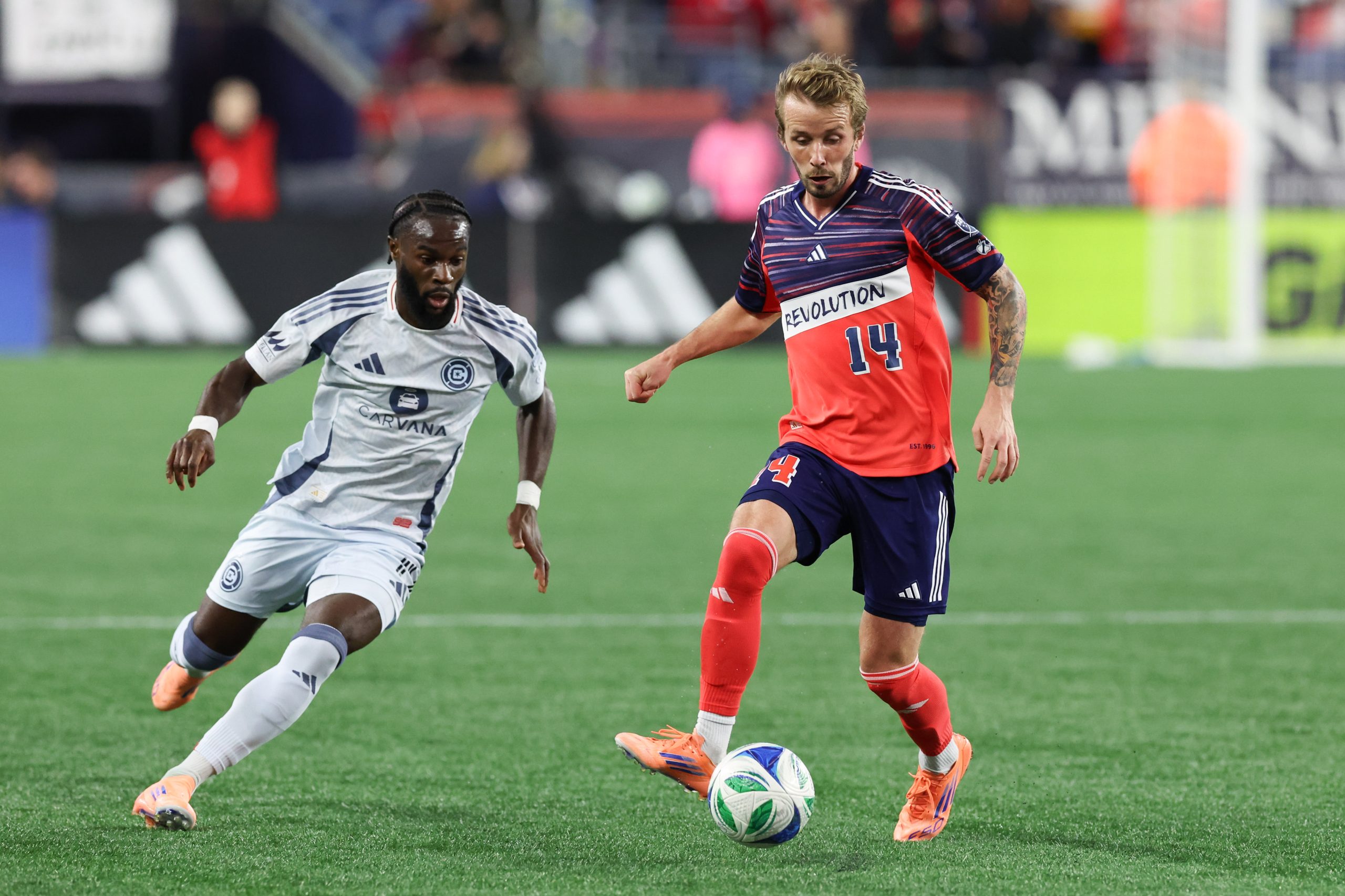 Oct 18, 2025; Foxborough, Massachusetts, USA; New England Revolution midfielder Jackson Yueill (14) passes the ball during the first half against Chicago Fire FC at Gillette Stadium. Mandatory Credit: Paul Rutherford-Imagn Images