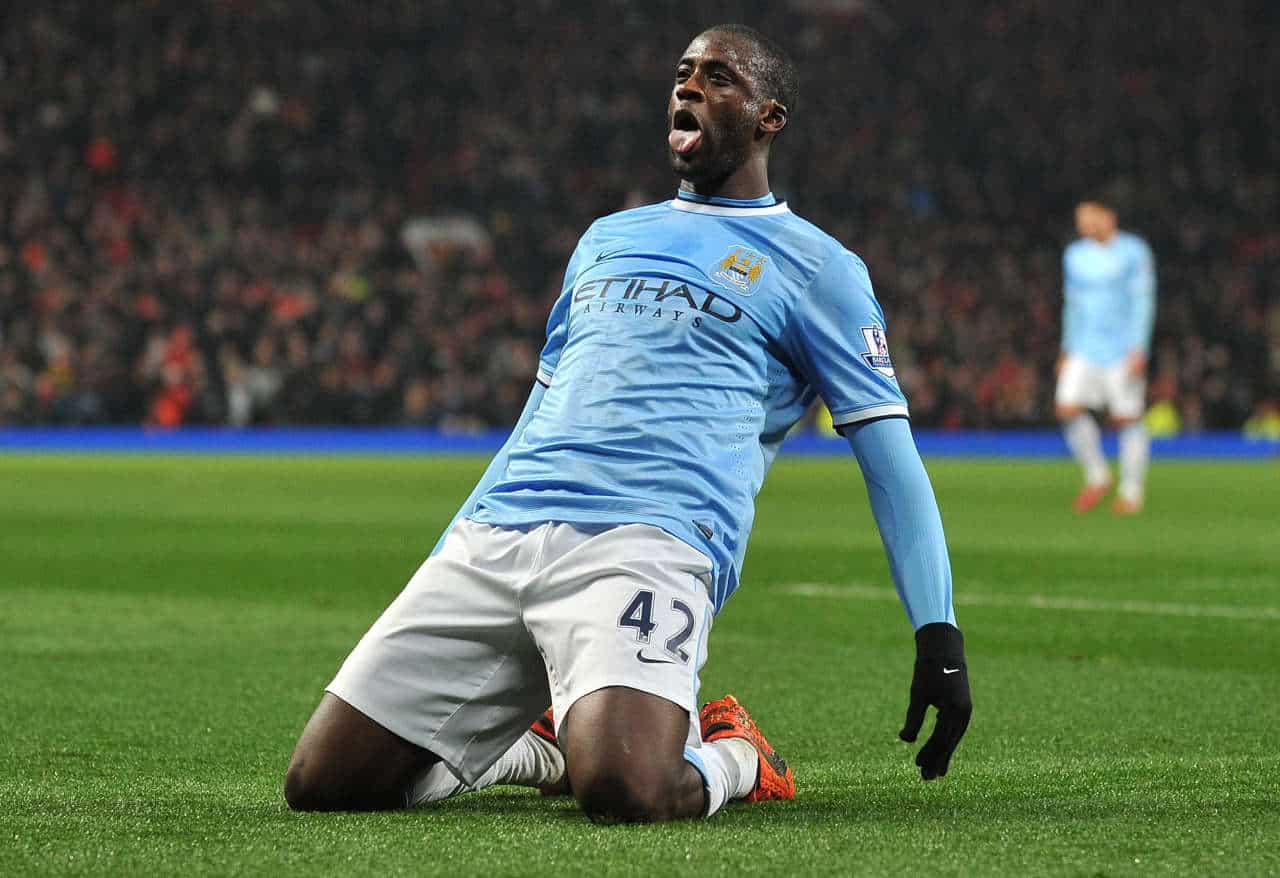 Manchester City's Ivorian defender Yaya TourÈ celebrates after scoring their third goal during the English Premier League football match between Manchester United and Manchester City at Old Trafford in Manchester on March 25, 2014. Manchester City won 3-0. AFP PHOTO/PAUL ELLIS - RESTRICTED TO EDITORIAL USE. No use with unauthorized audio, video, data, fixture lists, club/league logos or ìliveî services. Online in-match use limited to 45 images, no video emulation. No use in betting, games or single club/league/player publications.