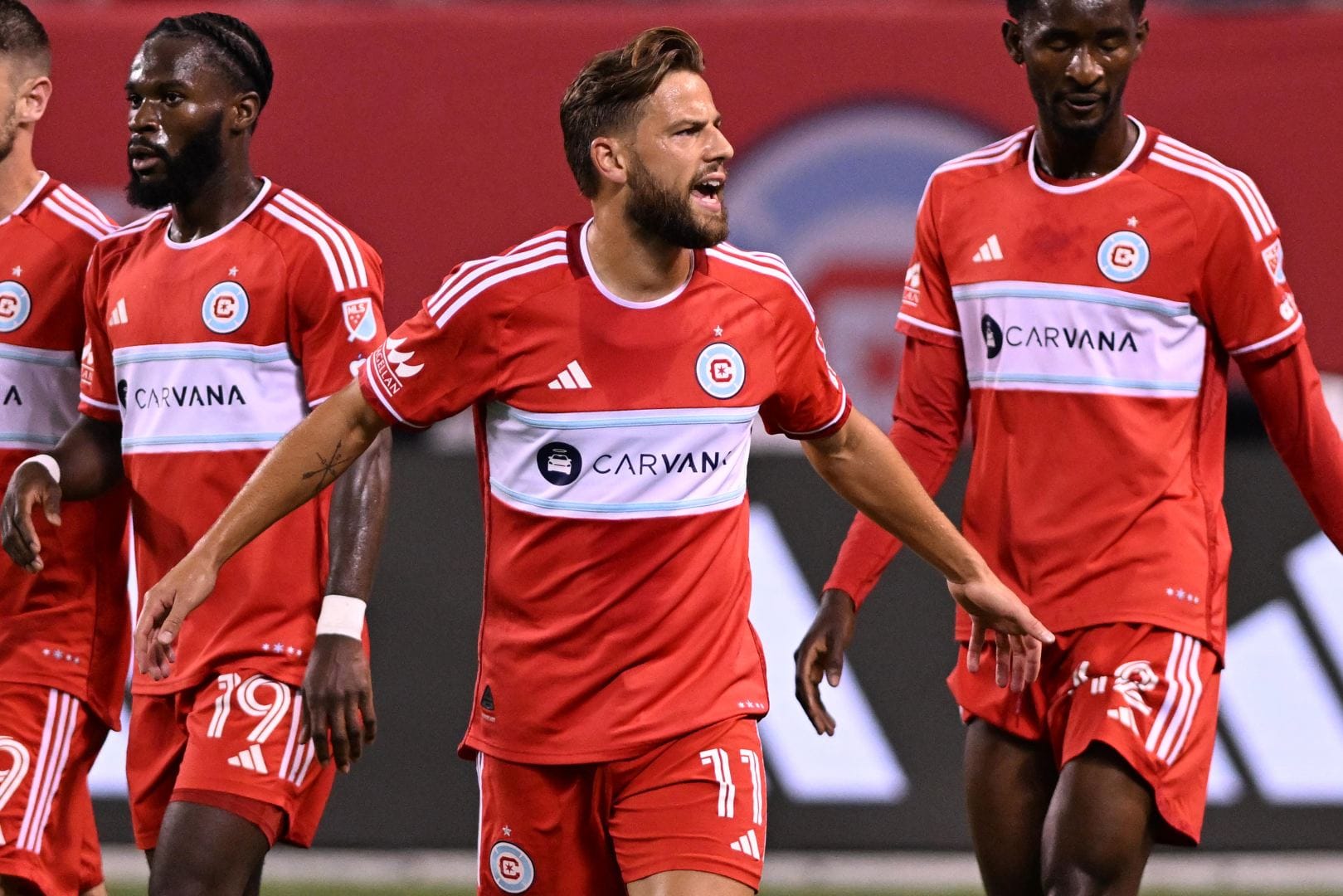 Philip Zinckernagel, Jonathan Bamba and Djé D'Avilla on the field during a game at Soldier Field.