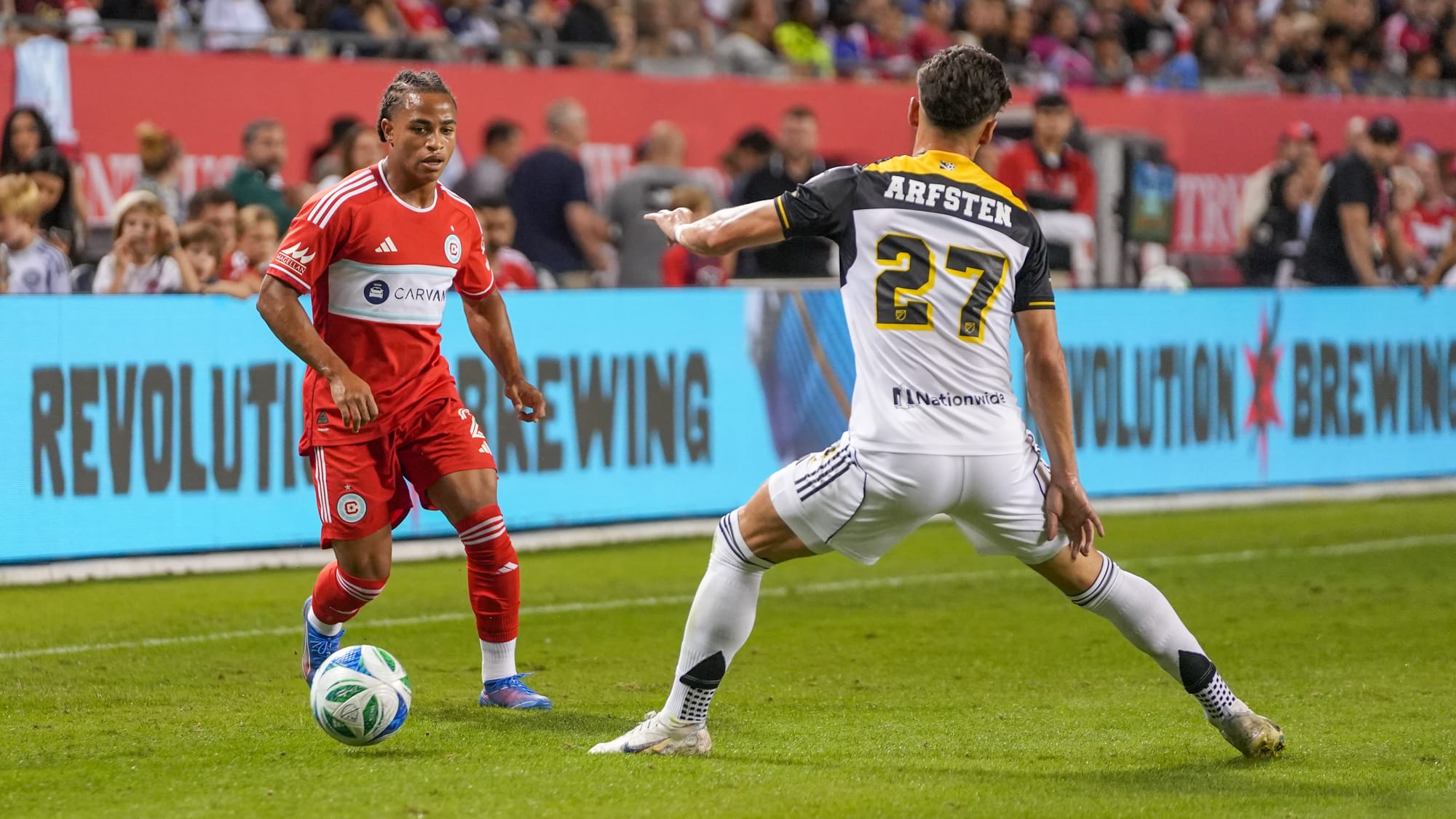 Chicago Fire defender Leonardo Barroso dribbles the ball against Columbus Crew defender Max Arfsten in 2025. (photo: Barbara Calabrese)