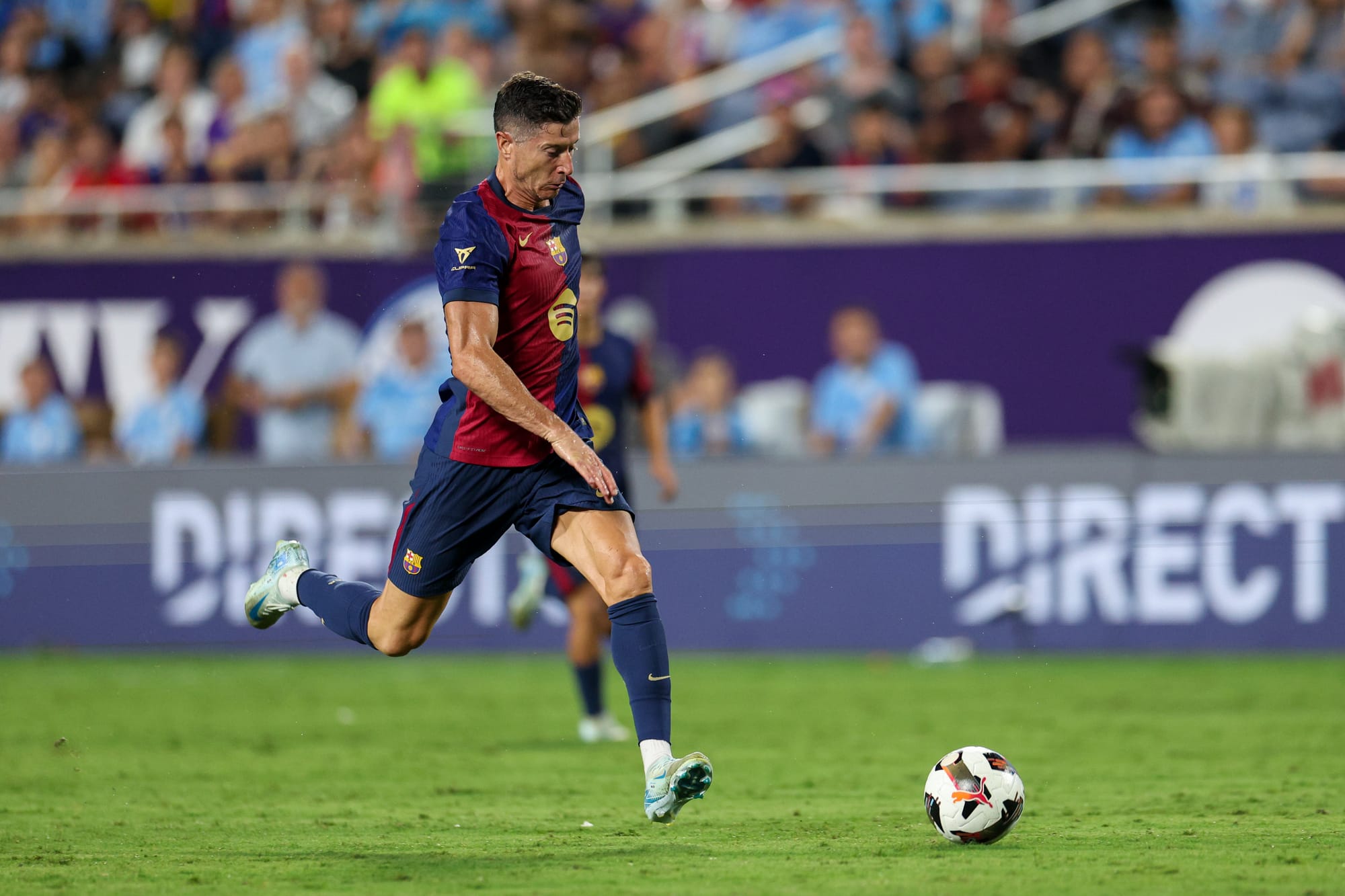 Jul 30, 2024; Orlando, FL, USA; Barcelona forward Robert Lewandowski (9) controls the ball against Manchester City in the second half during a Champions Tour friendly match at Camping World Stadium.