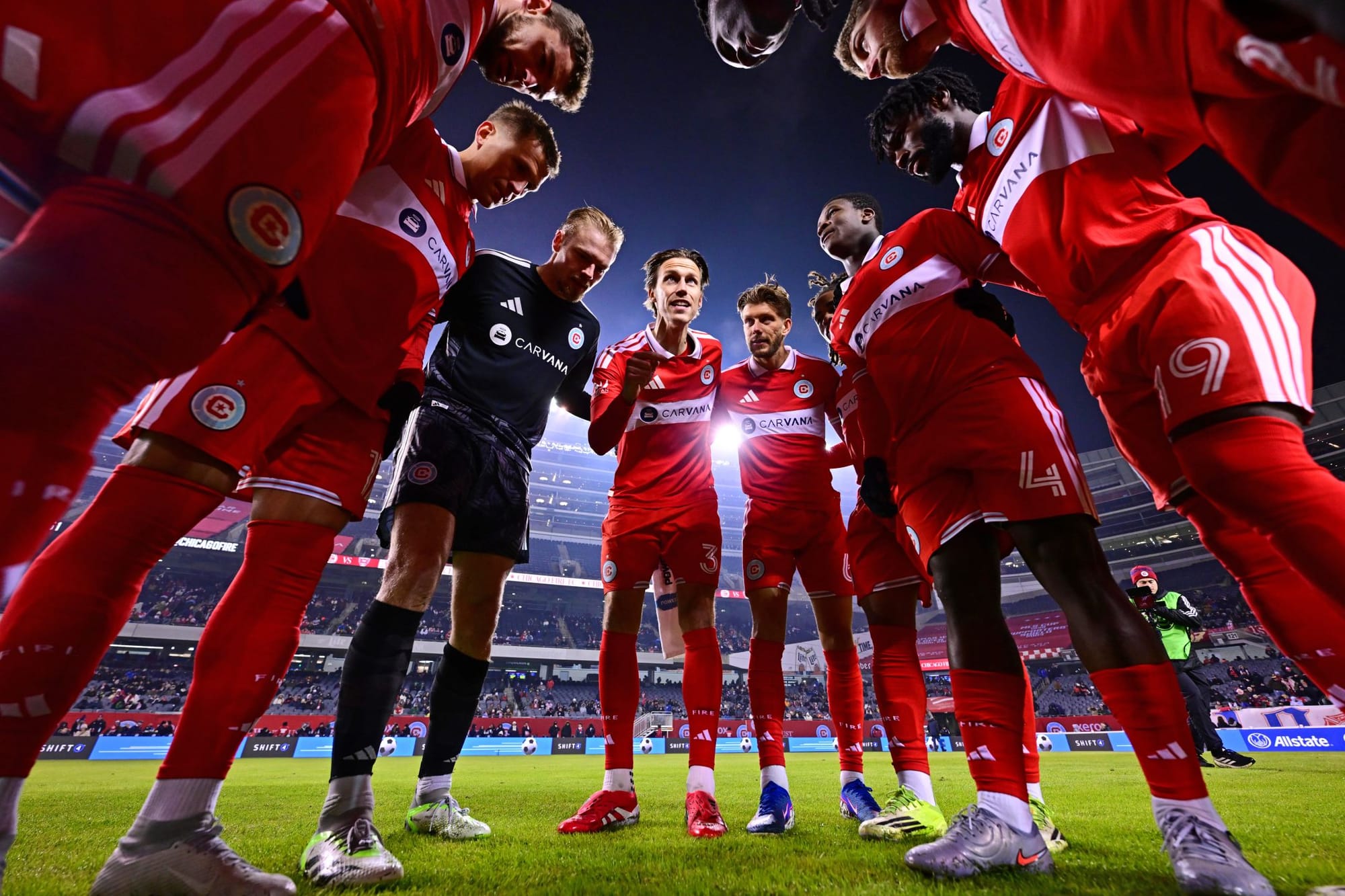 Chicago Fire FC huddle ahead of a game at Soldier Field