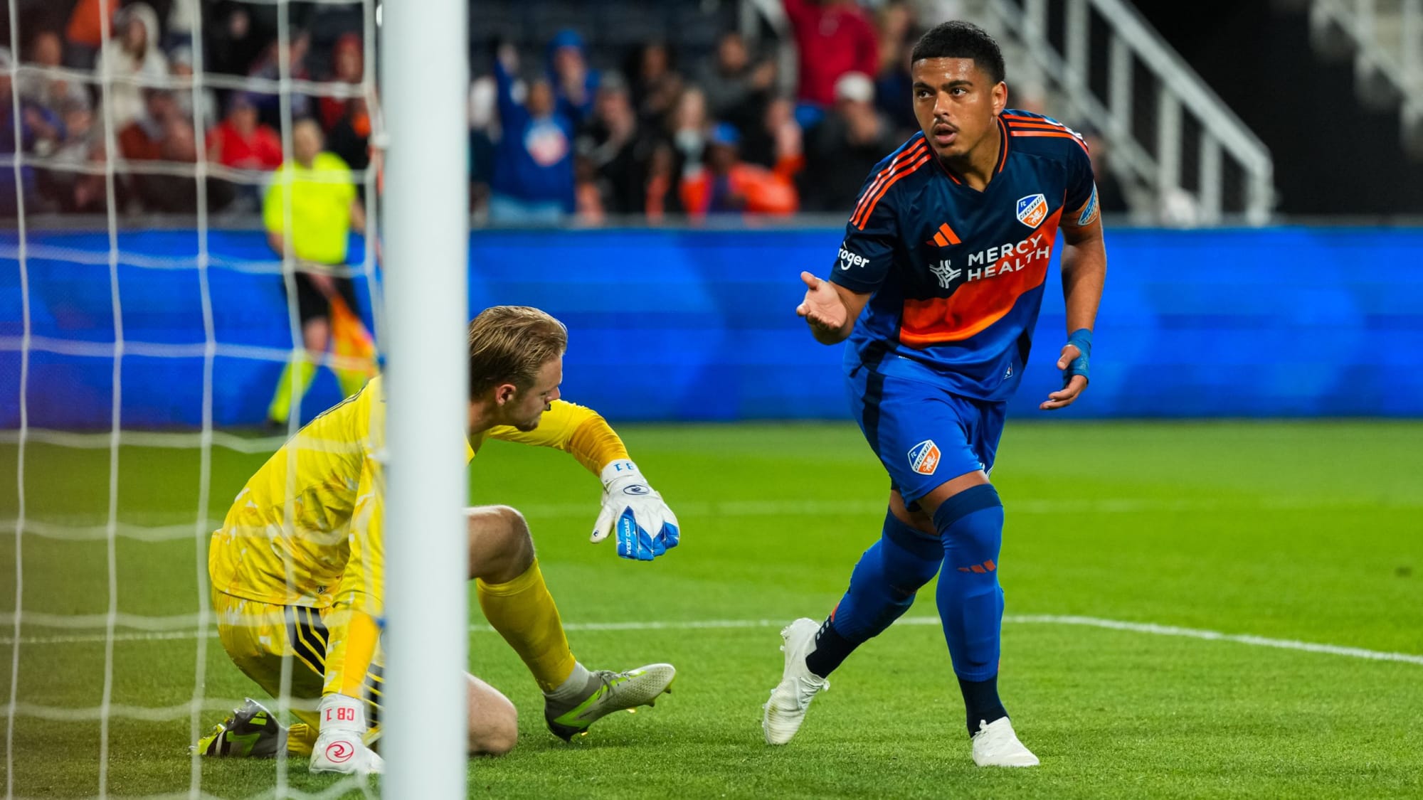 Evander celebrating as he scores a goal on the Chicago Fire's Chris Brady for FC Cincinnati