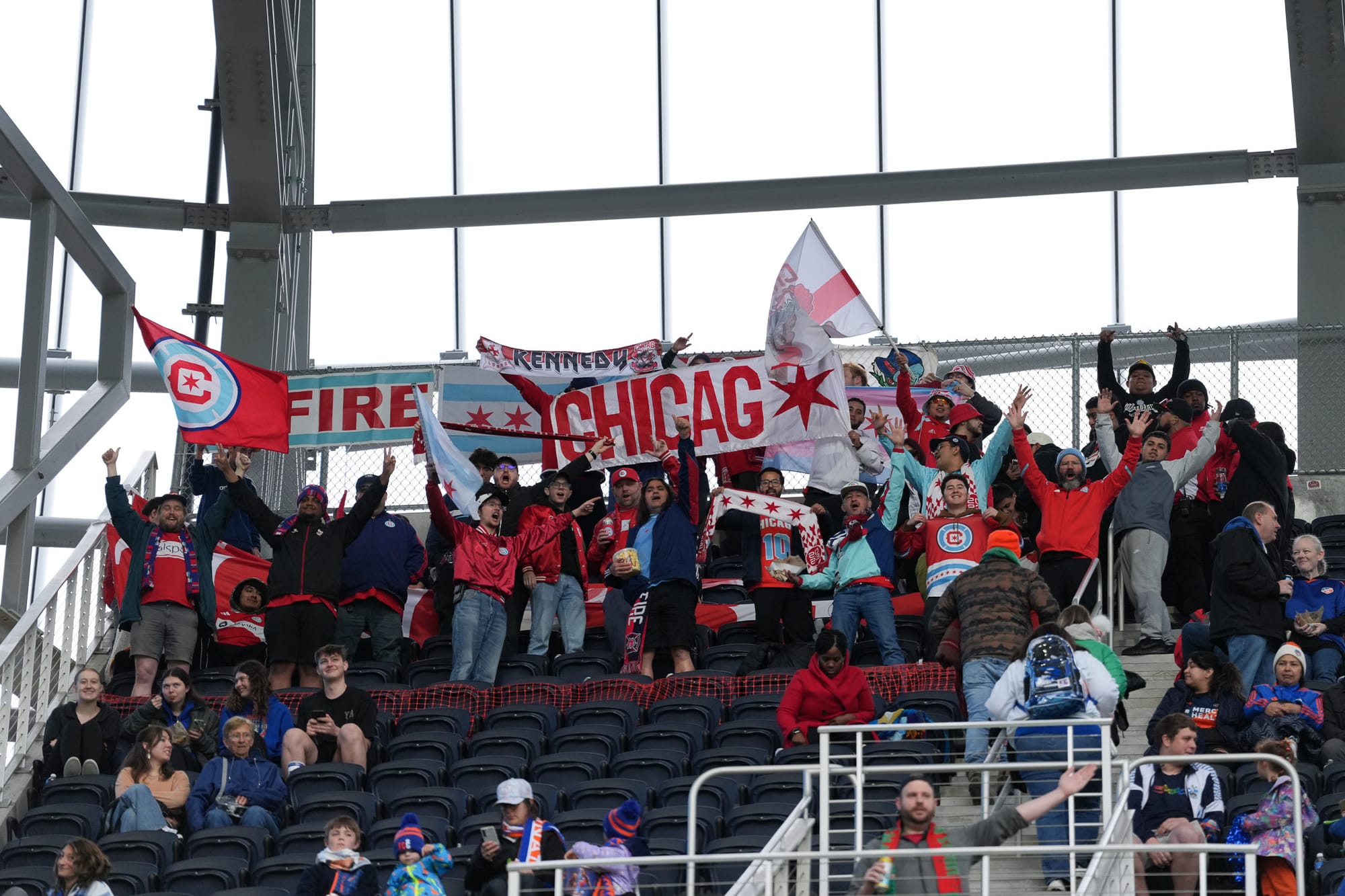 A group of Chicago Fire supporters with banners at TQL Stadium ahead of the Fire's match against FC Cincinnati.