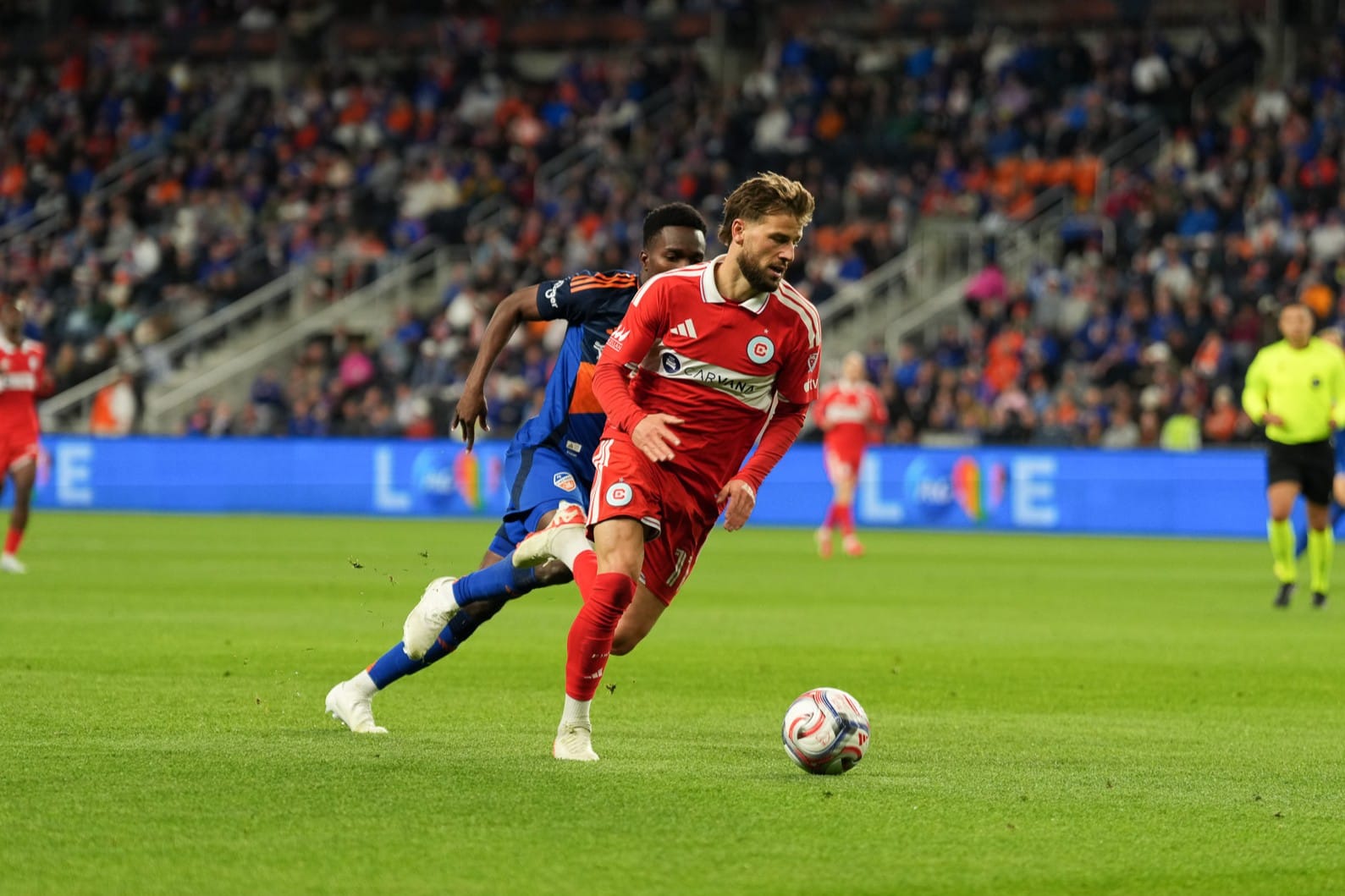 The Chicago Fire's Philip Zinckernagel plays the ball against FC Cincinnati during a soccer game.