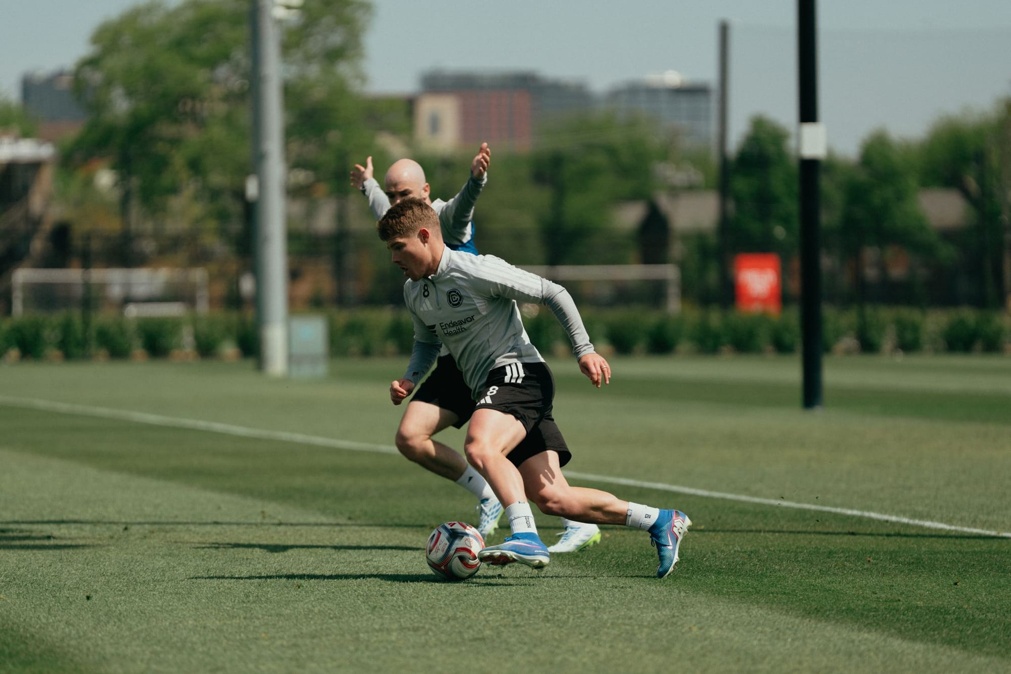 Chris Mueller and Andrew Gutman contest the ball during training.