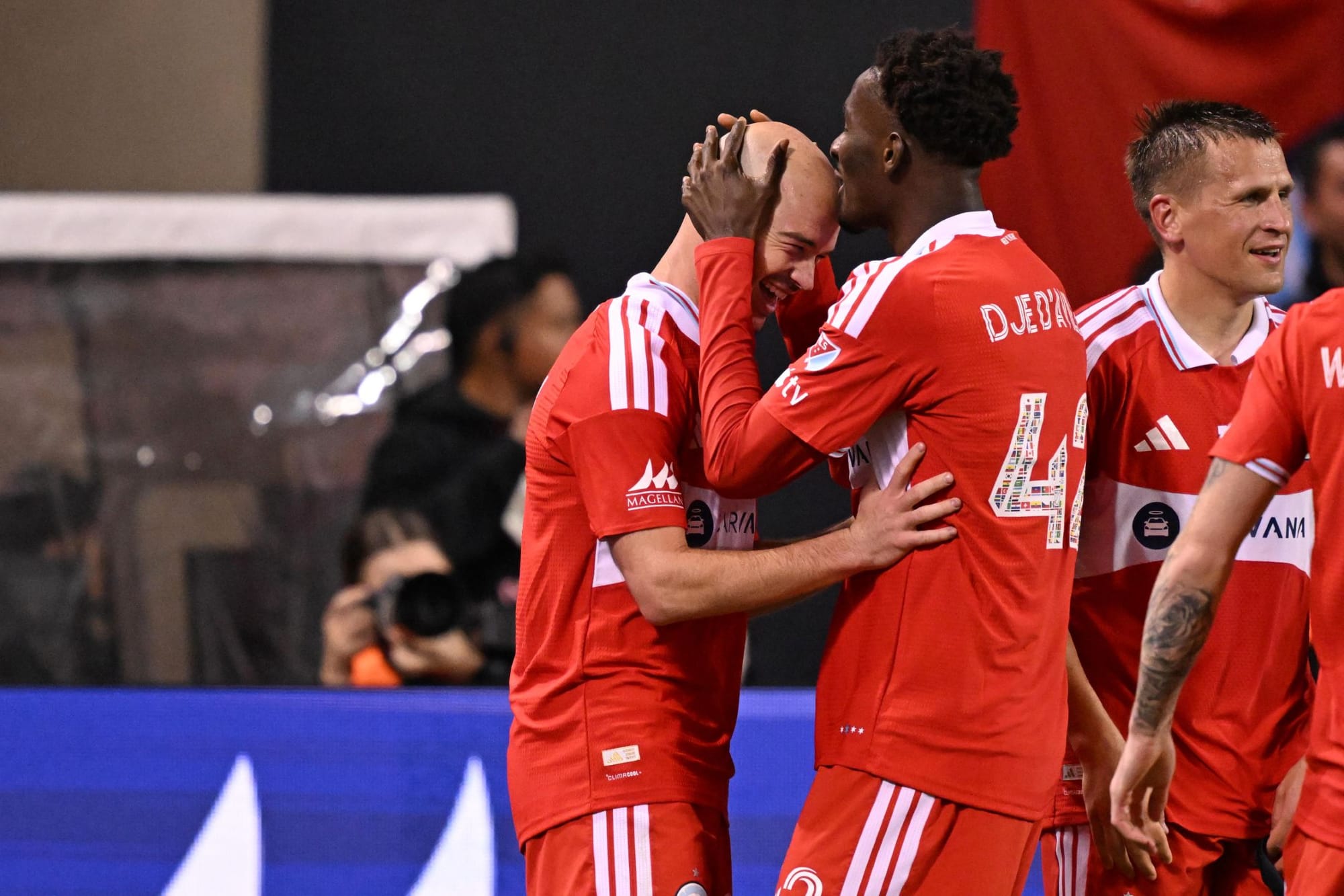The Chicago Fire's Djé D'Avilla kisses Andrew Gutman's forehead after he scored against Toronto FC.