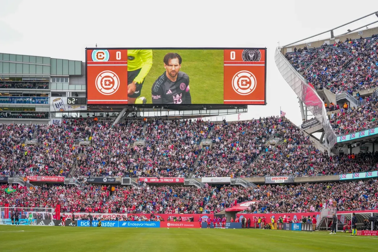 Chicago Fire vs Inter Miami at a packed Soldier Field in 2025, showing Lionel Messi on the jumbotron 