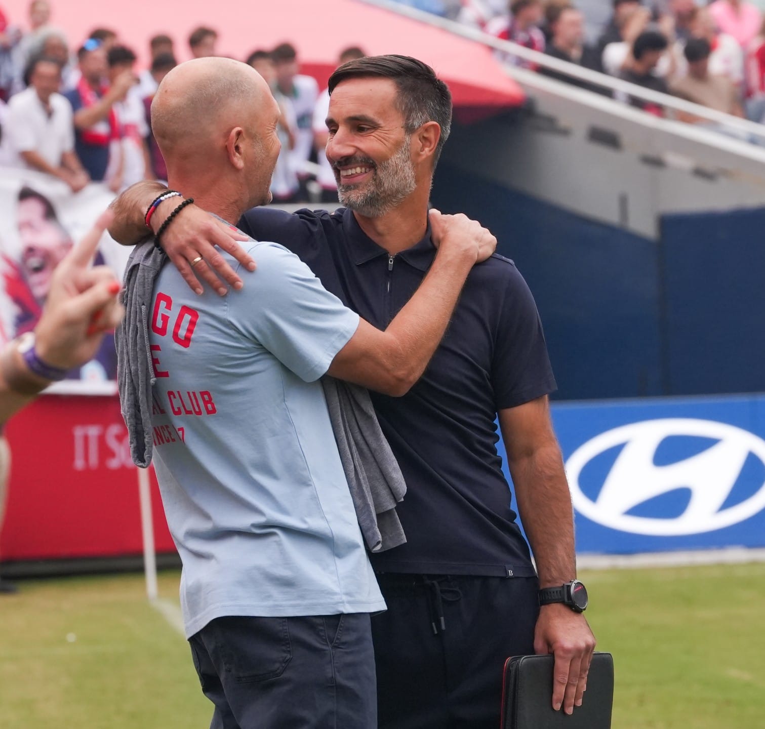 Gregg Berhalter and Marko Mitrovic embracing before the Fire's game against the Revs.