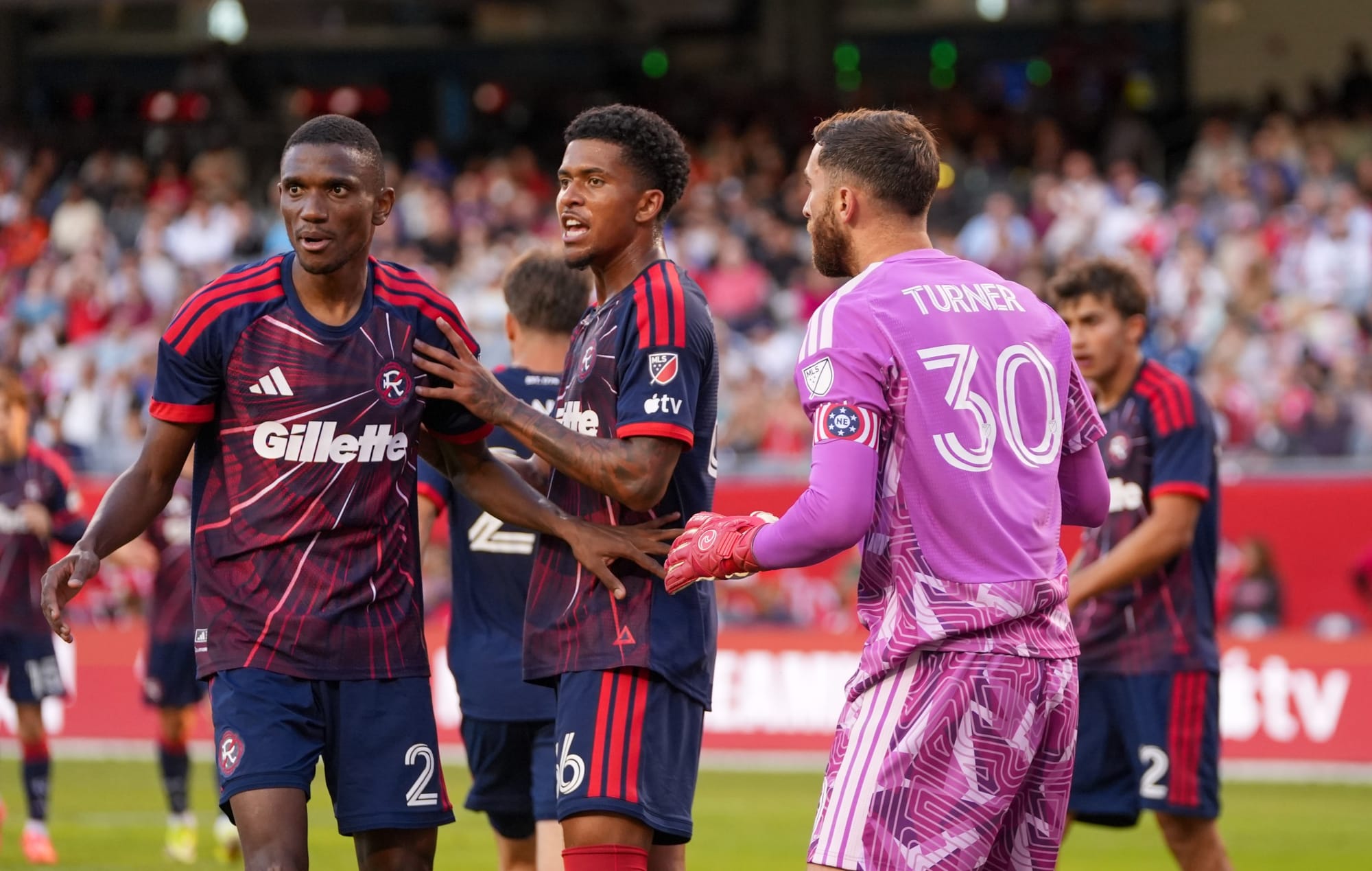 Matt Turner (30) and other New England Revolution players during their game against the Chicago Fire at Soldier Field.