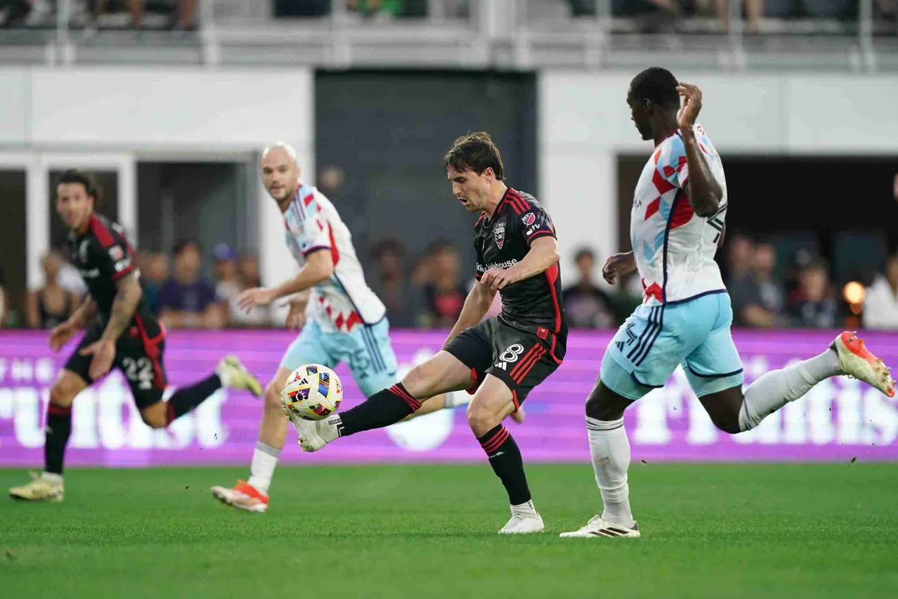 May 25, 2024; Washington, District of Columbia, USA; D.C. United midfielder Jared Stroud (8) plays the ball defended by Chica
